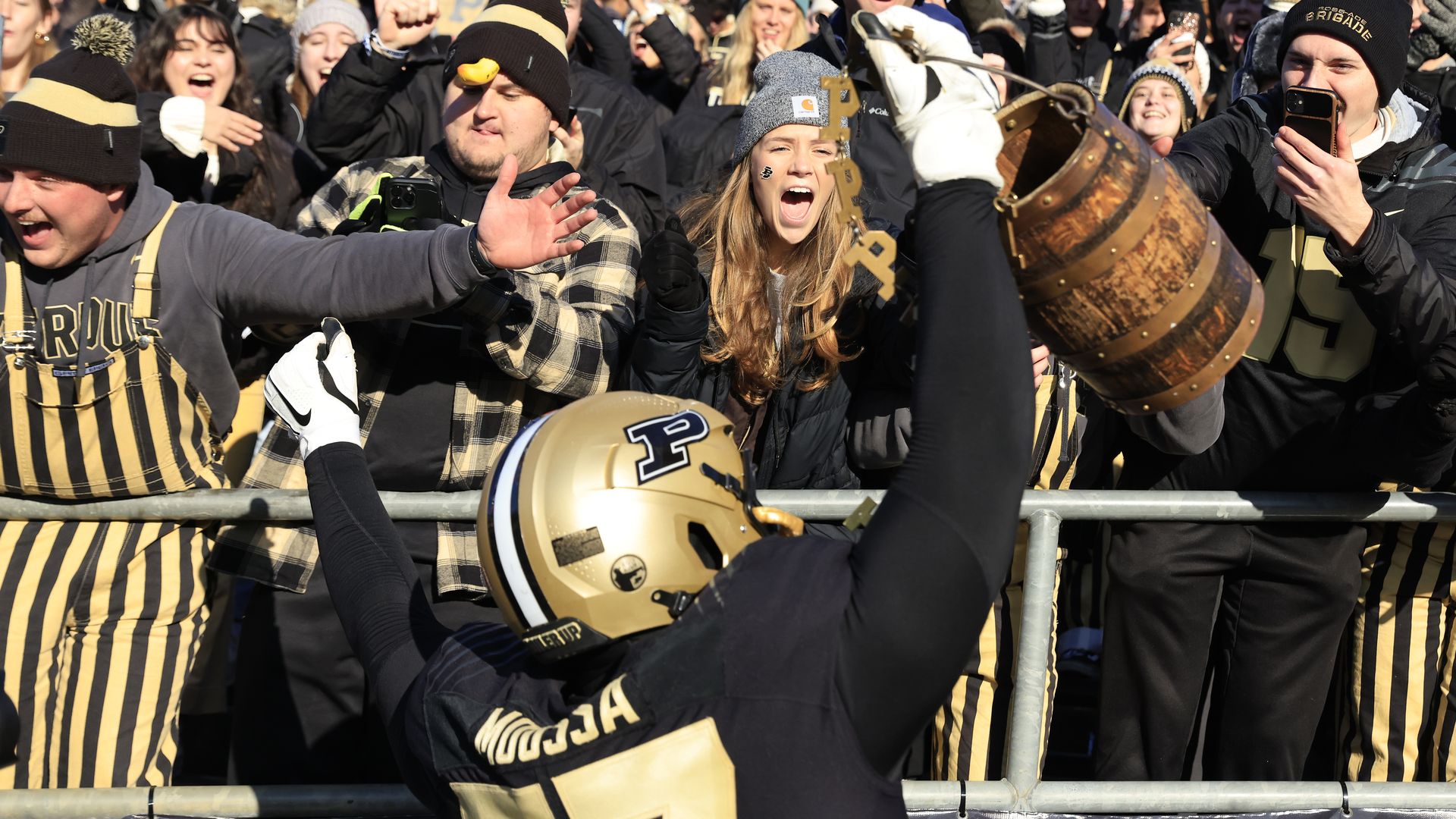 Mahamane Moussa #77 of the Purdue Boilermakers celebrates winning the Old Oaken Bucket over Indiana Hoosiers with fans at Ross-Ade Stadium on November 25, 2023 in West Lafayette, Indiana. 