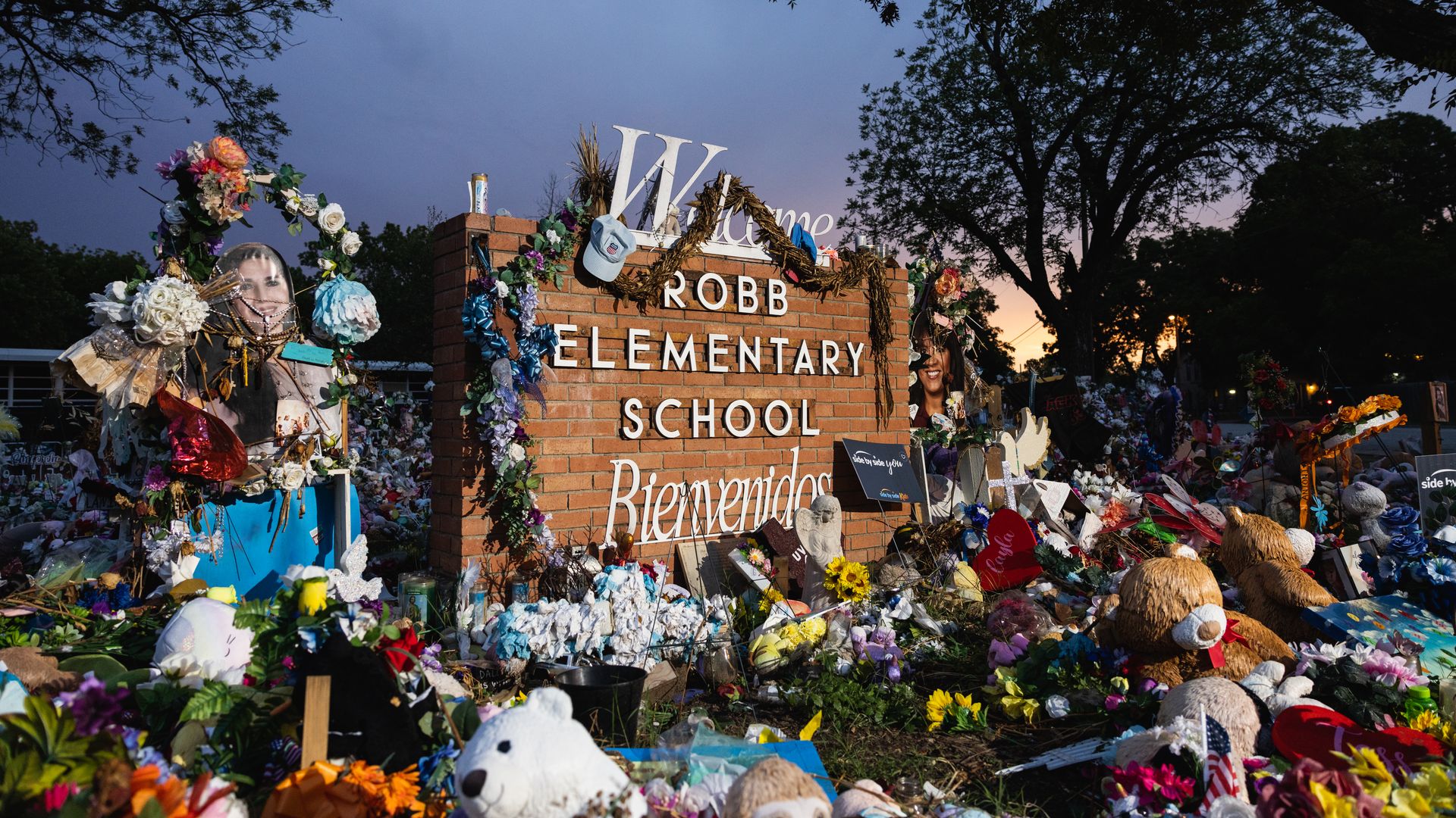 The sun sets behind the memorial for the victims of the massacre at Robb Elementary School on August 24, 2022 in Uvalde, Texas.