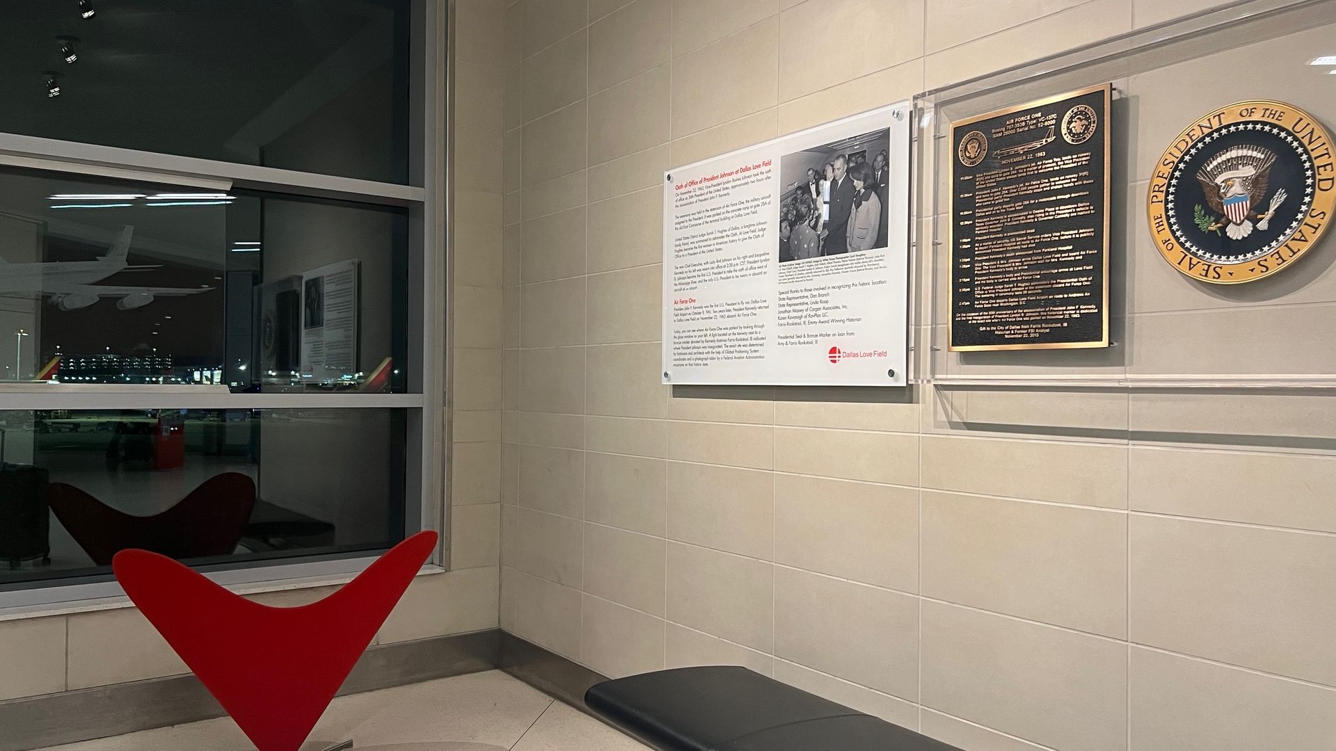 A plague overlooking an airport runway