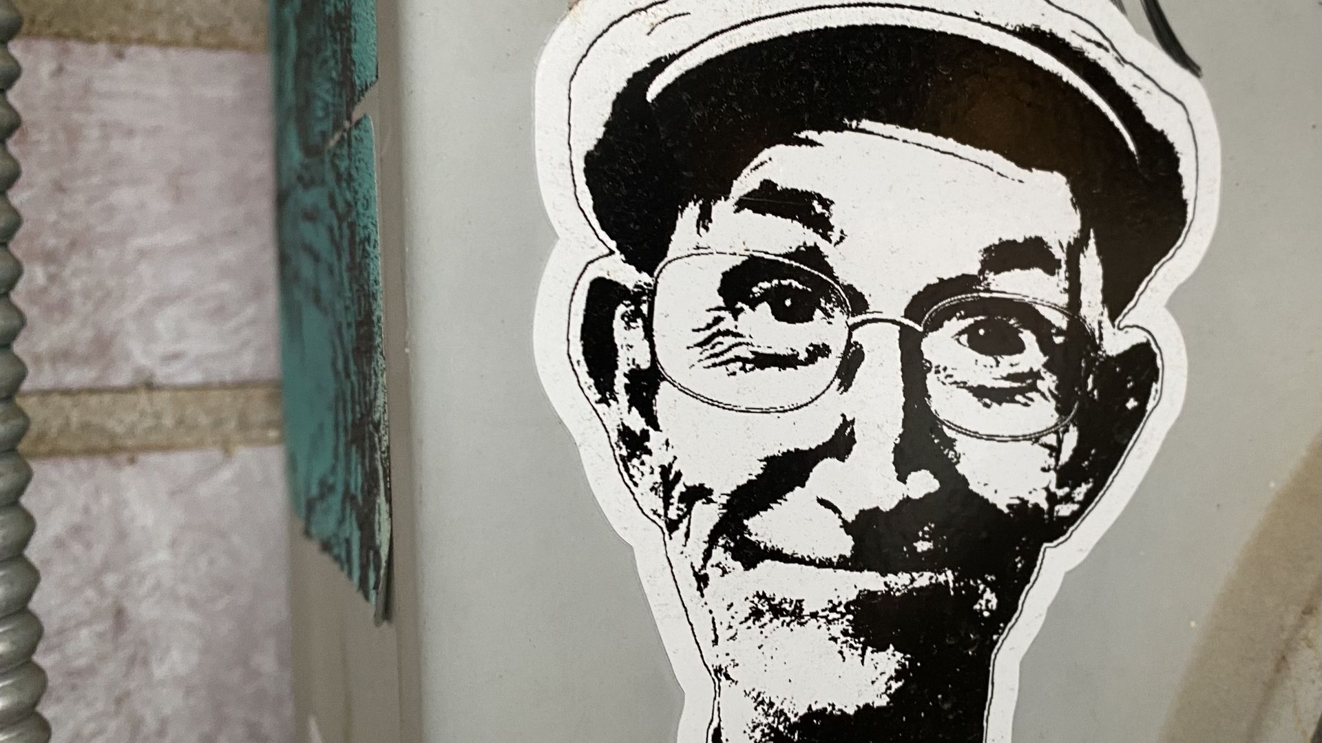 sticker of The Funky Geezer, a 70-something musician wearing glasses and a sly smirk.