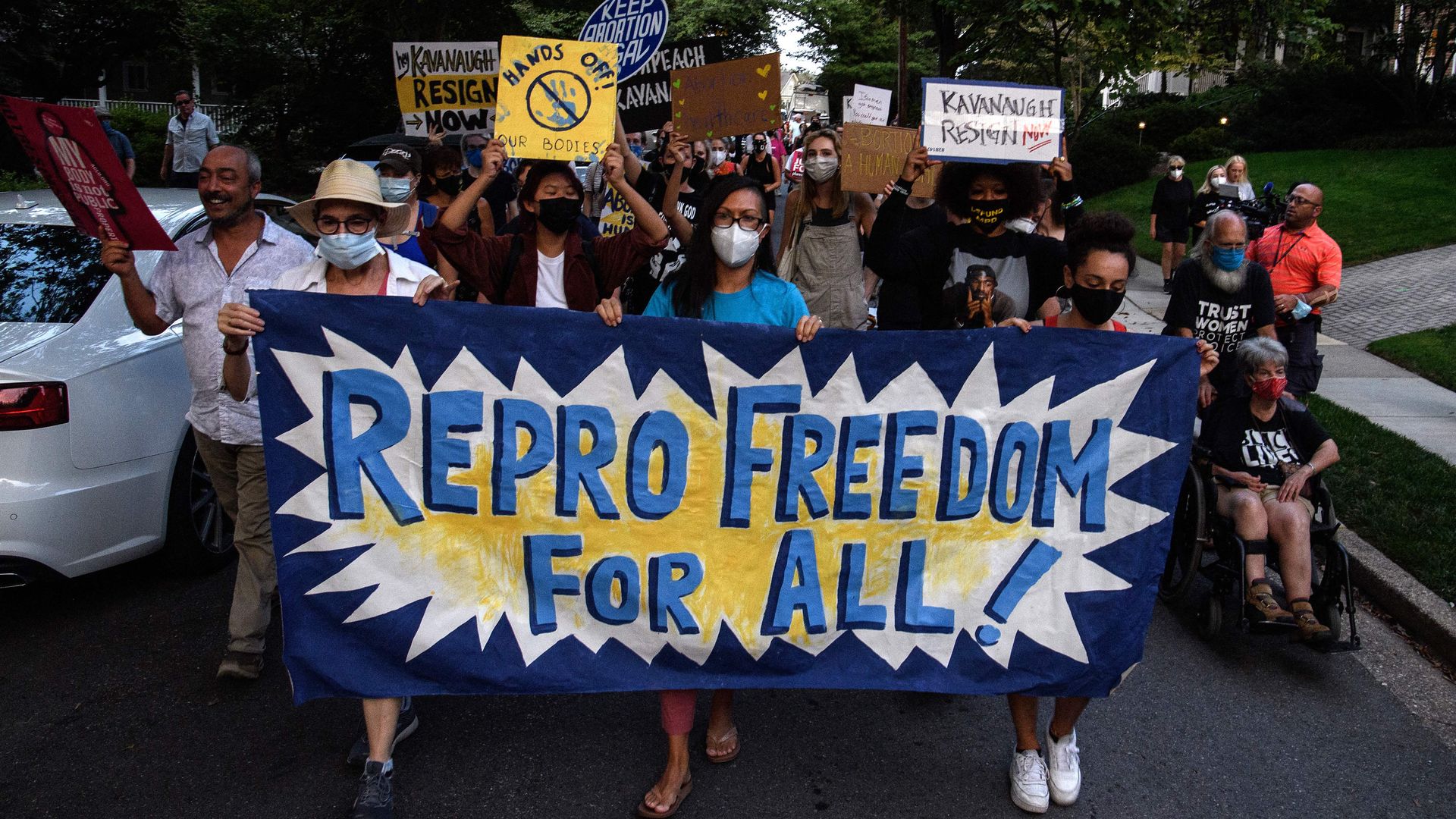 Photo of a group of pro-abortion advocates holding banners