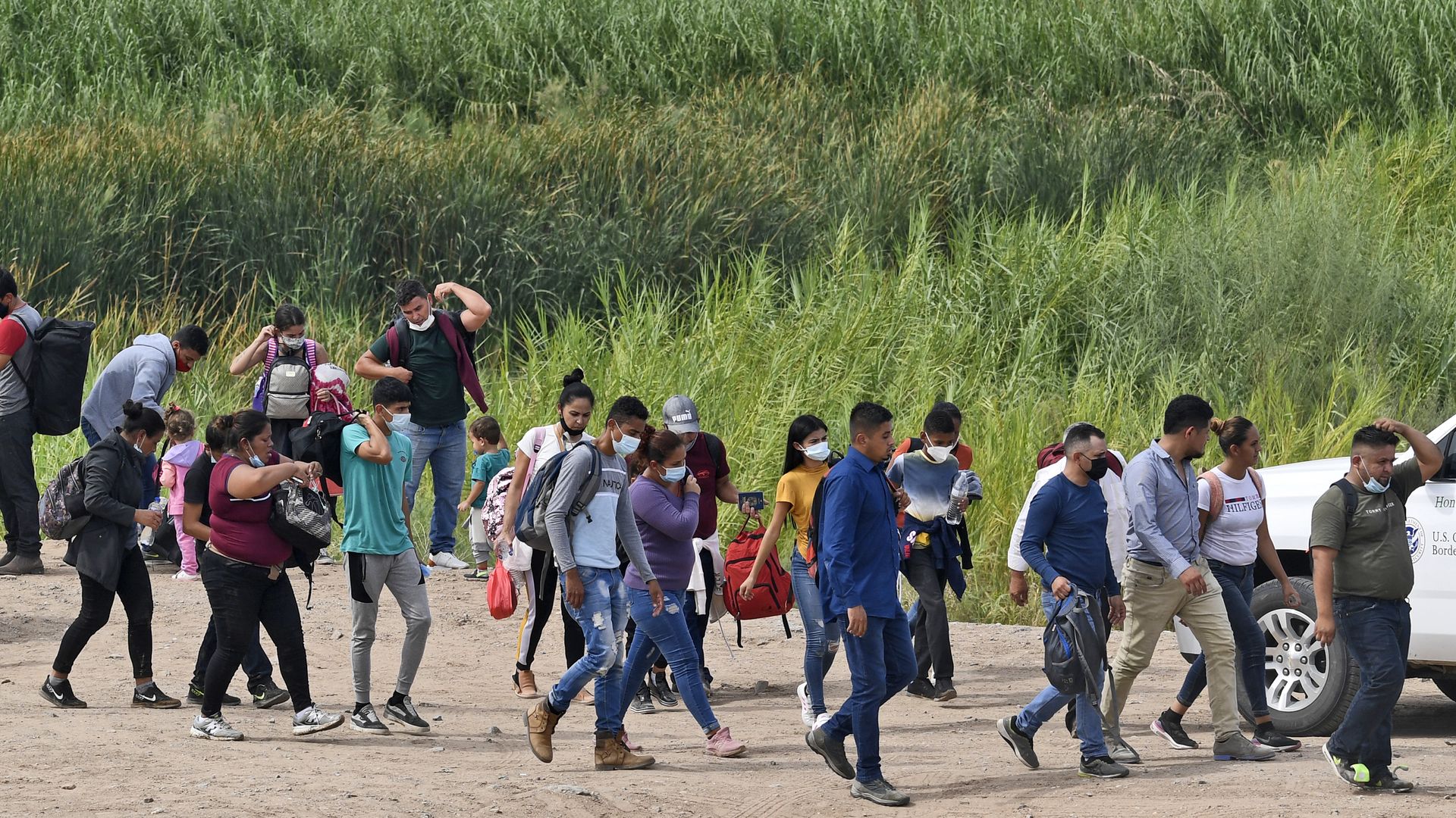 Migrants attempting to cross in to the U.S. from Mexico are detained by U.S. Customs and Border Protection at the border