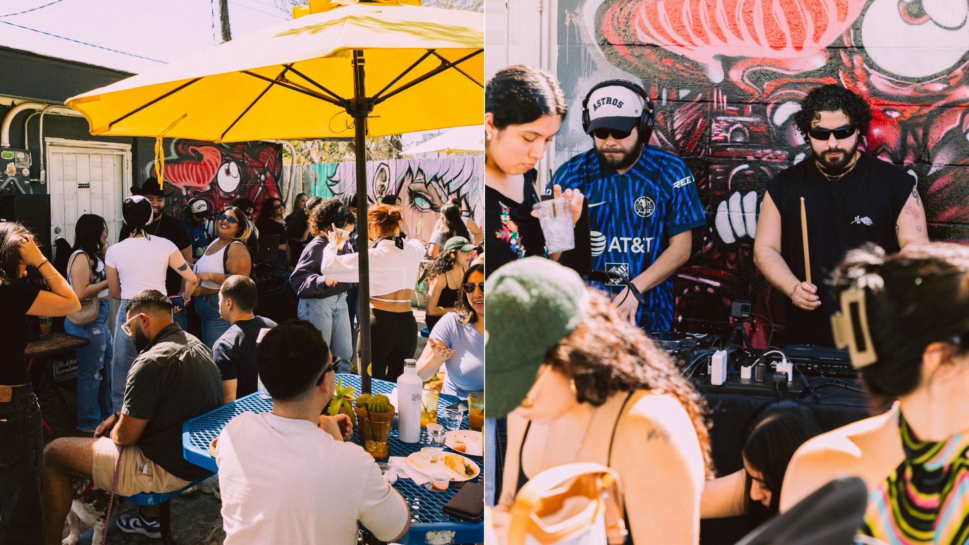 Outdoor social gathering with diverse people sitting and standing under yellow umbrellas, colorful mural wall, and two men DJing near graffiti art, one holding drumsticks.