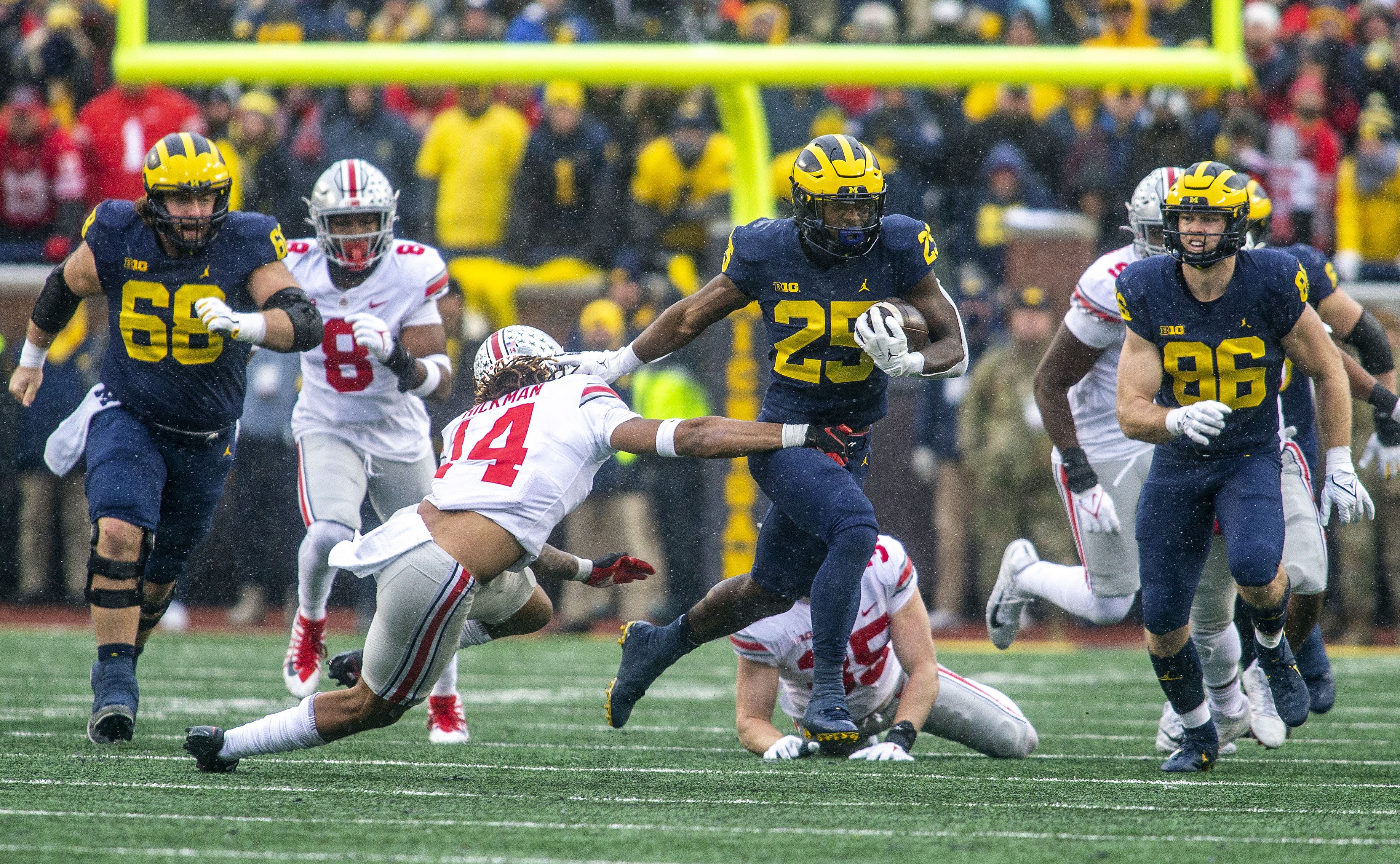 A Michigan runningback eludes an Ohio State defender.  