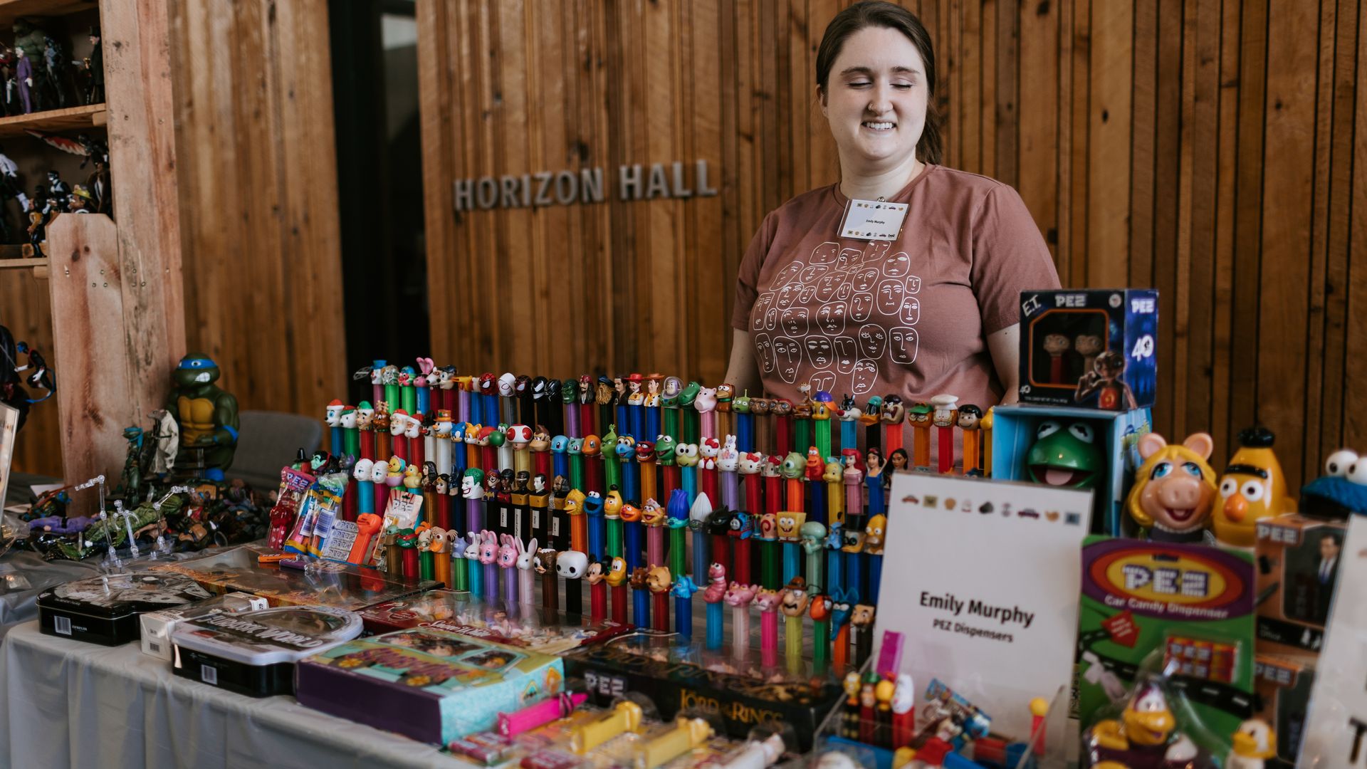 A picture of a woman with a large amount of PEZ dispensers.