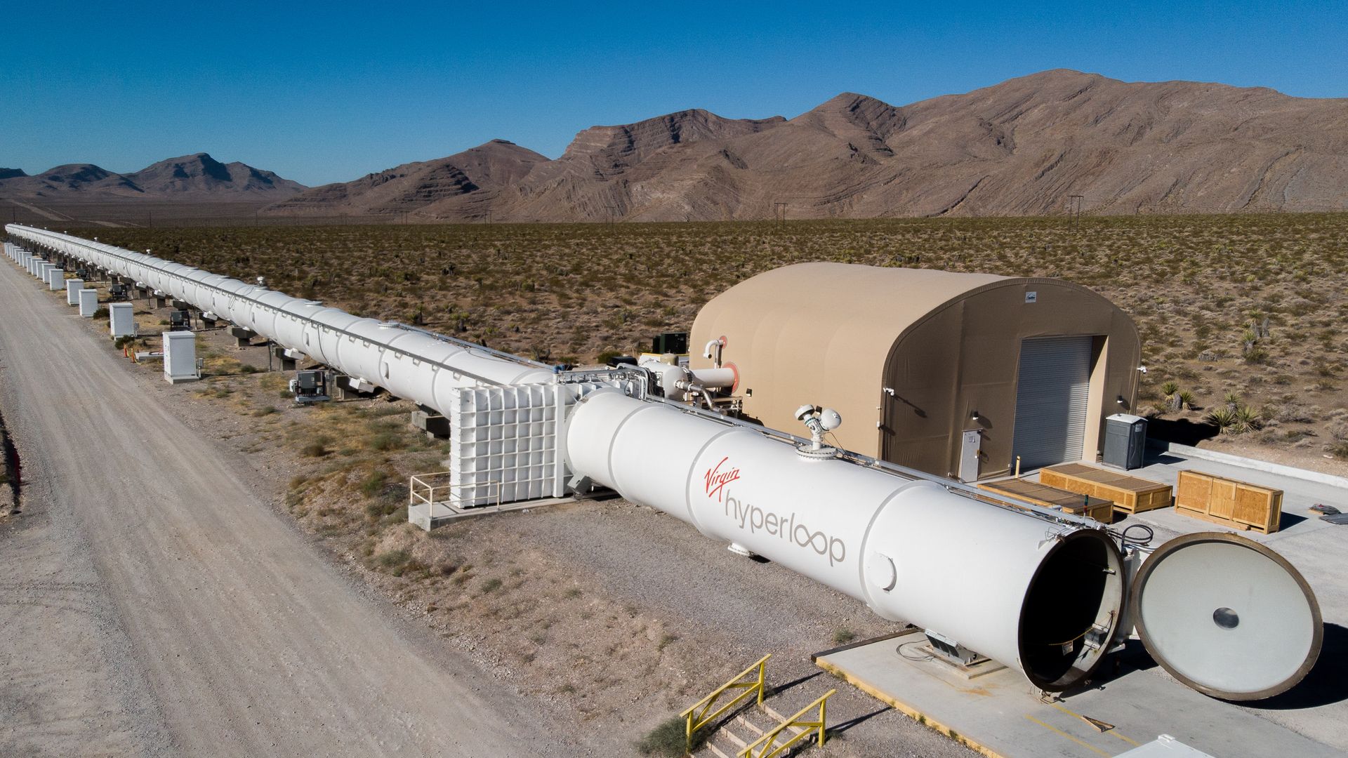 A white hyperloop tube constructed across a Nevada desert test site