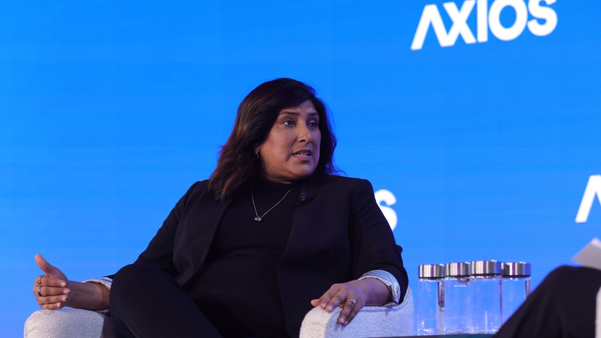 Photo of Navrina Singh in a black dress on stage at Axios' AI+ DC Summit