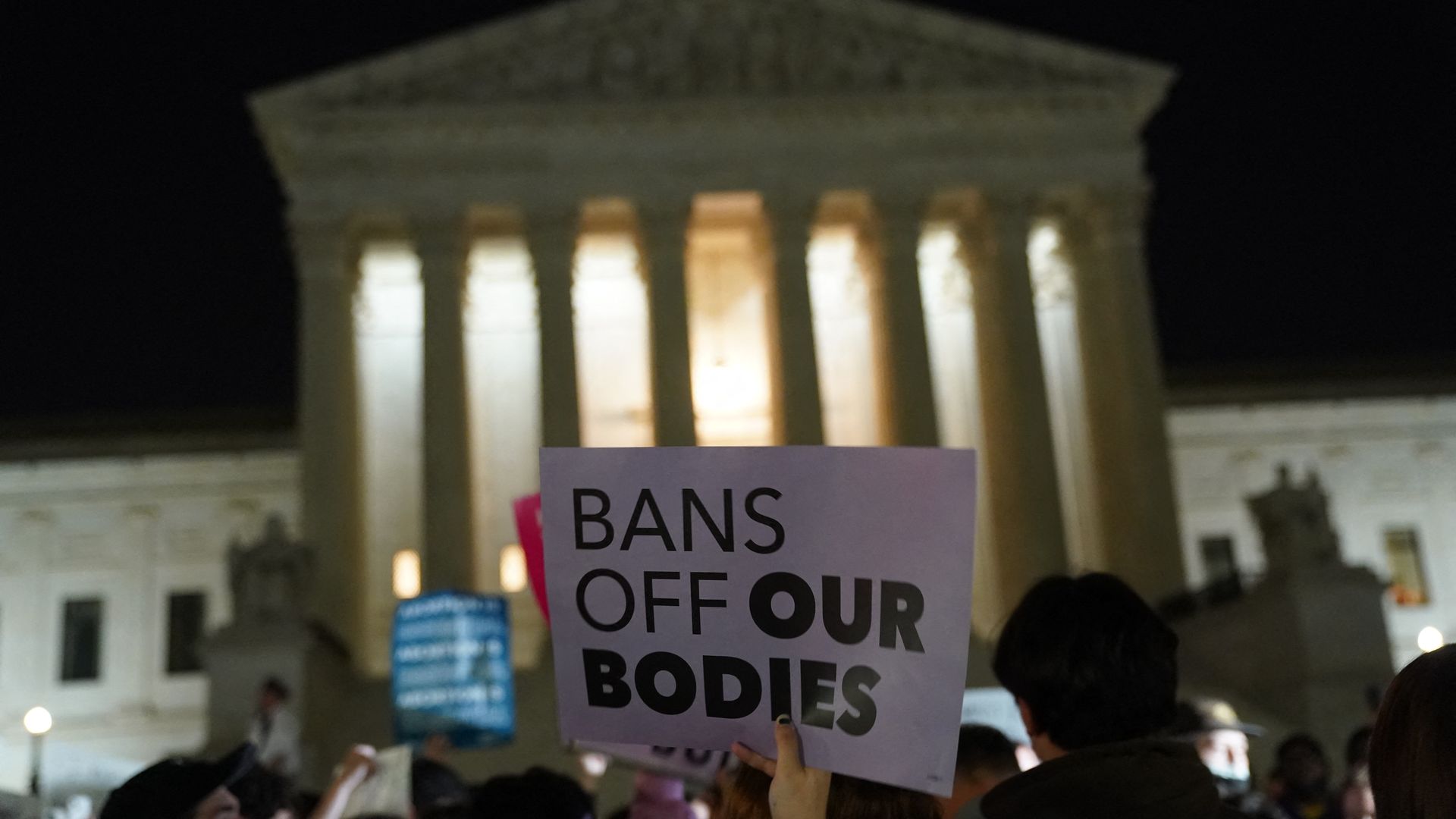 A protest in front of the U.S. Supreme Court building with a sign reading, "Bans Off Our Bodies."