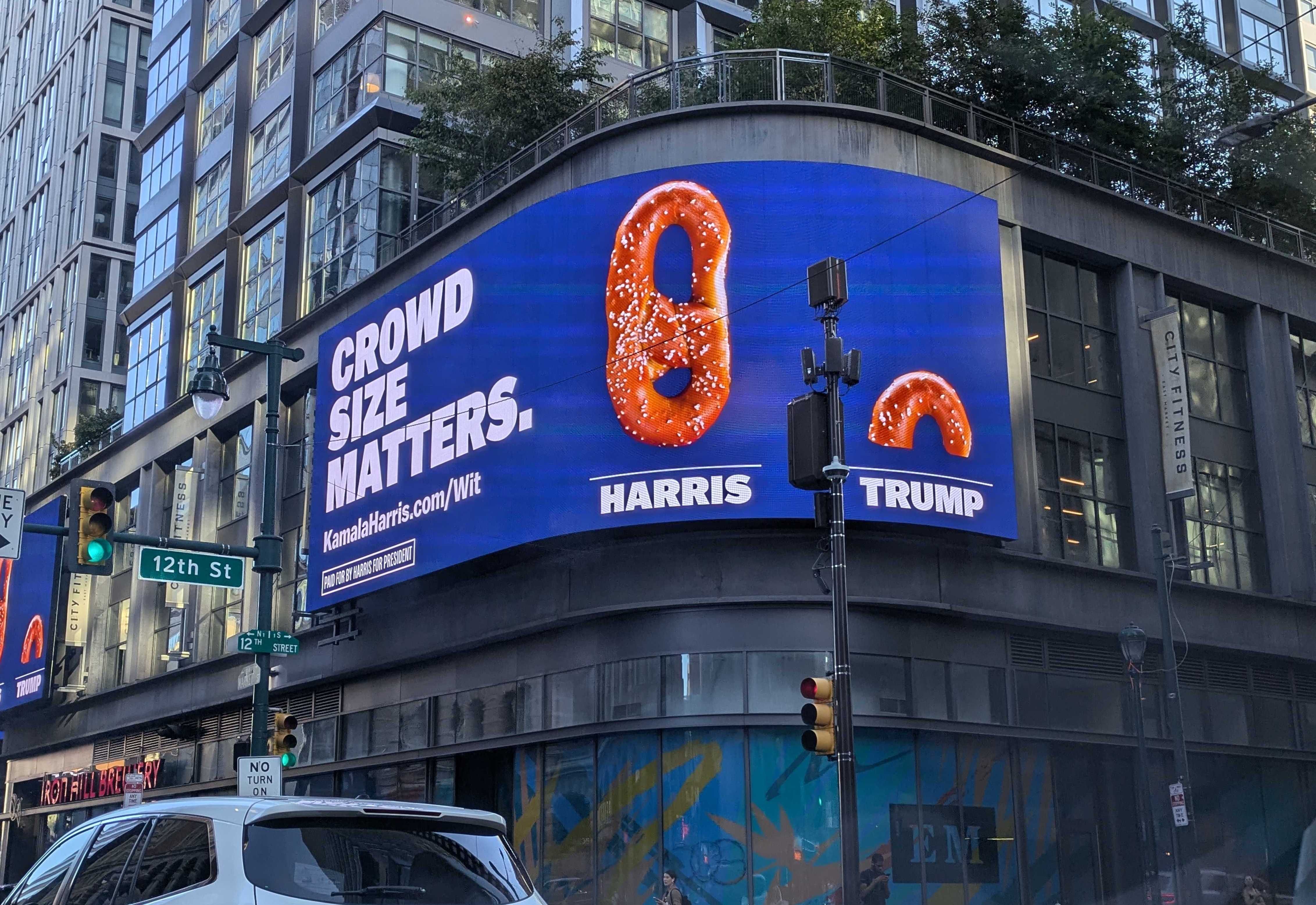A Harris campaign billboard with a pretzel that says "Crowd size matters."