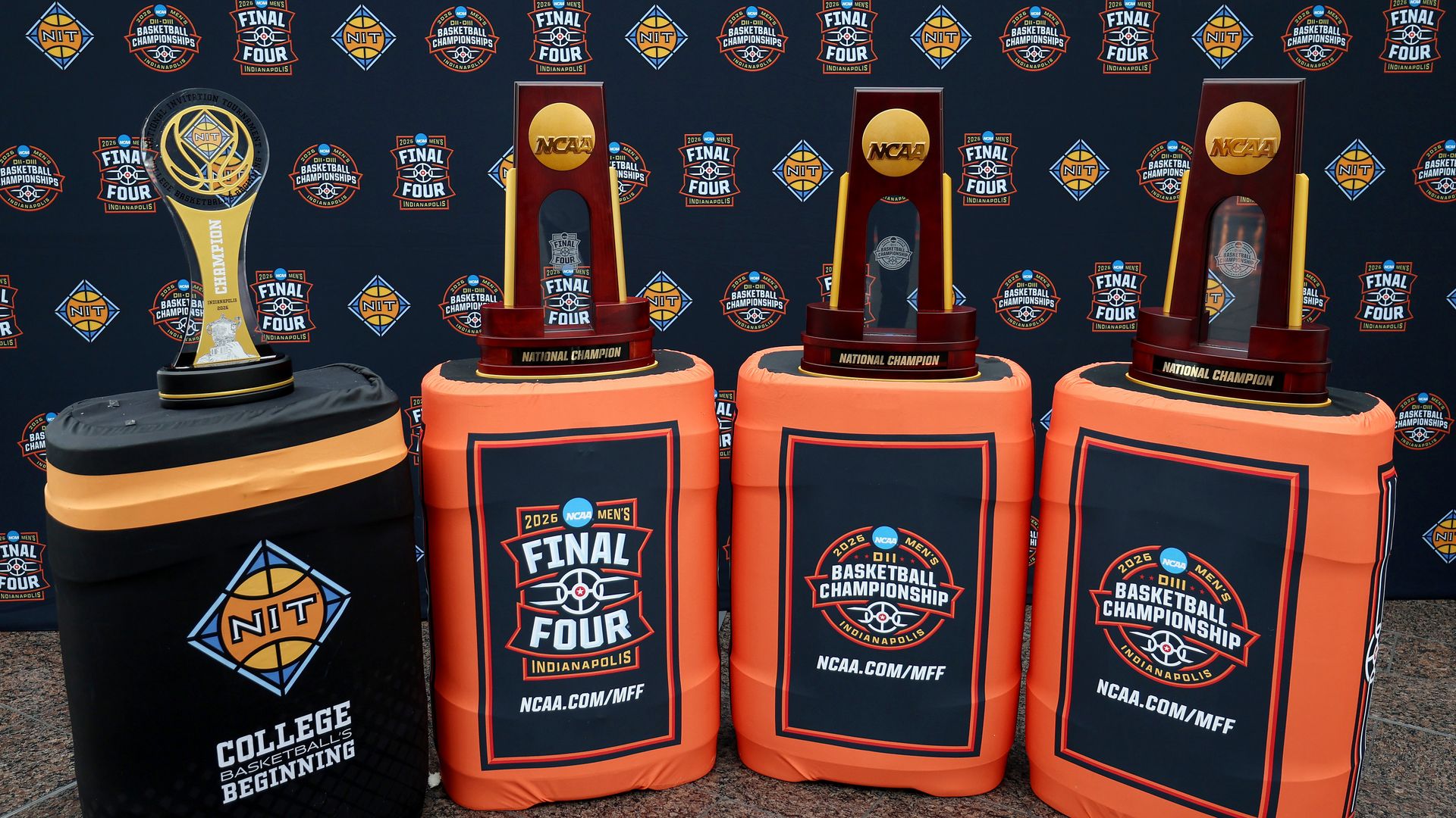The 2026 NCAA Men's Basketball Division 1, 2, and 3 tournament championship trophies are displayed alongside the NIT trophy at Indianapolis International Airport on March 31, 2026 in Indianapolis, Indiana.