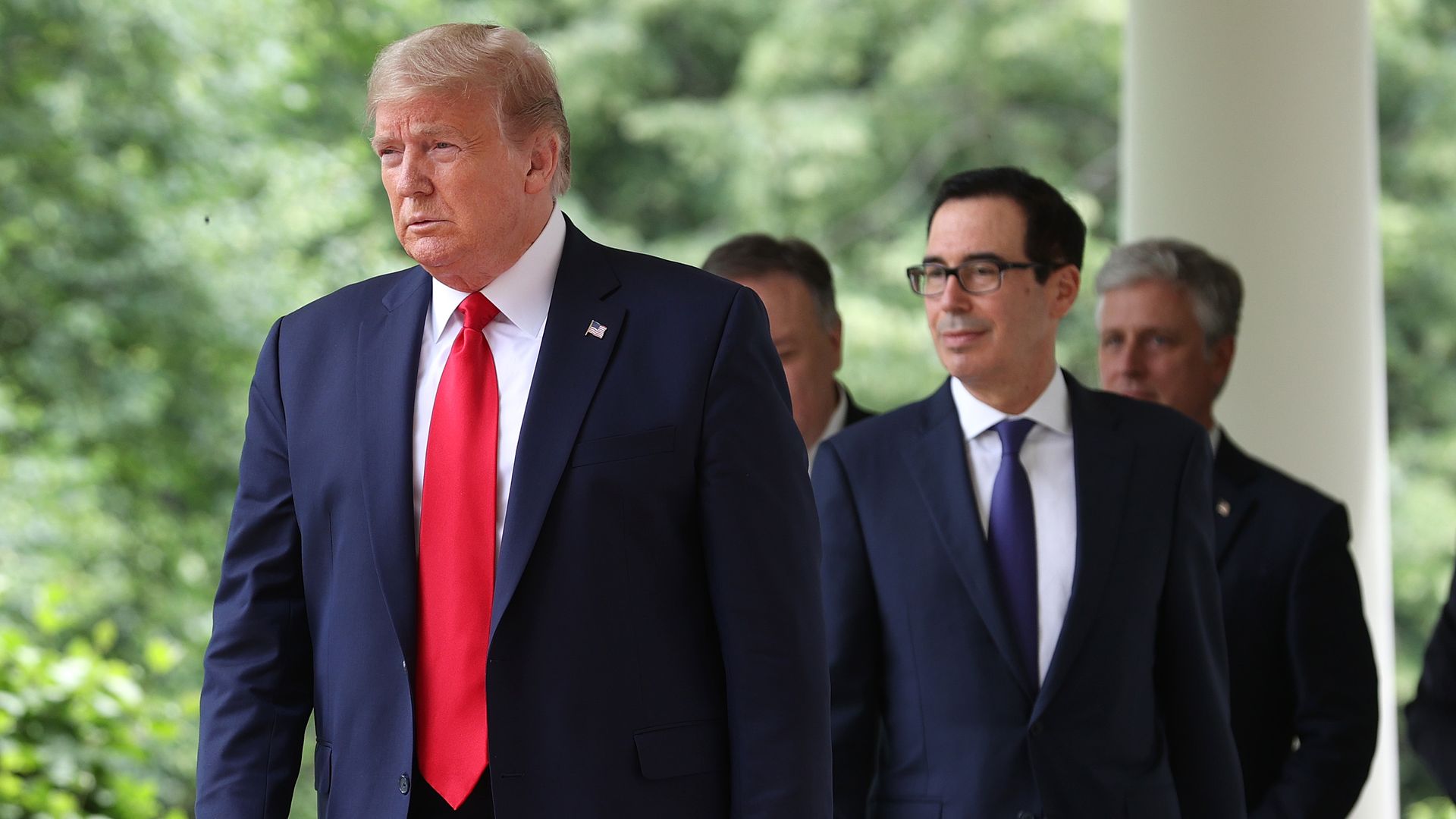 President Trump walking towards the Rose Garden followed by Treasury Secretary Steven Mnuchin
