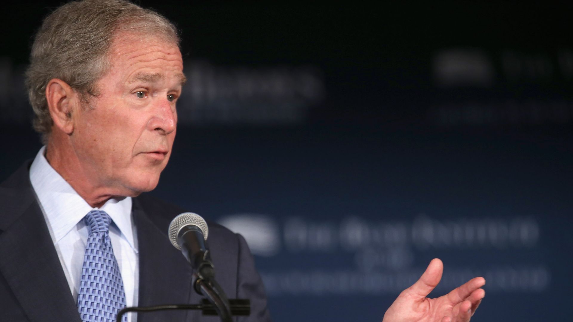 President George W. Bush at a podium.
