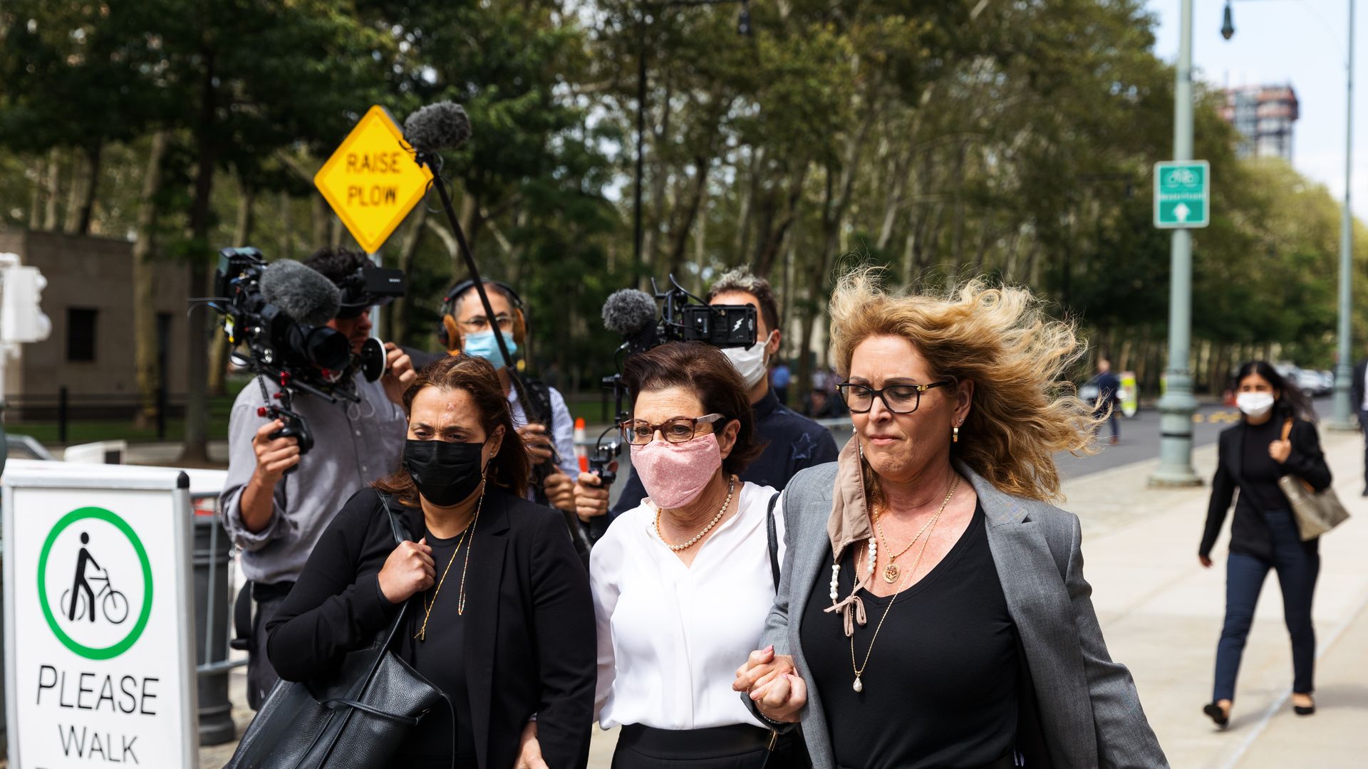 Nancy Salzman walking with two people outside of federal court
