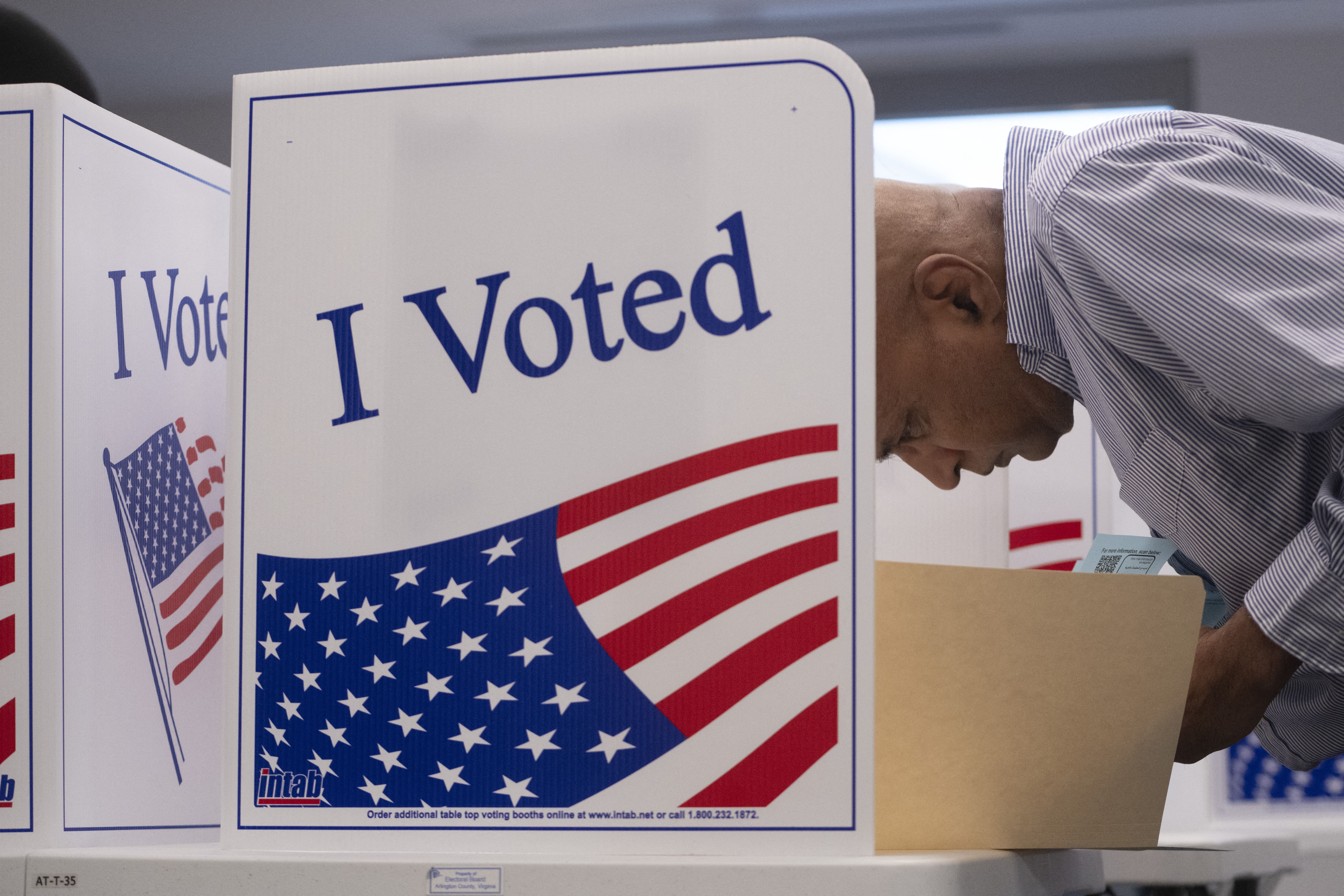 A voter works on his ballot at a polling station at the Elena Bozeman Government Center in Arlington, Virginia, on September 20, 2024. Early in-person voting for the 2024 US presidential election began in Virginia, South Dakota and Minnesota. (Photo by AFP) (Photo by -/AFP via Getty Images)