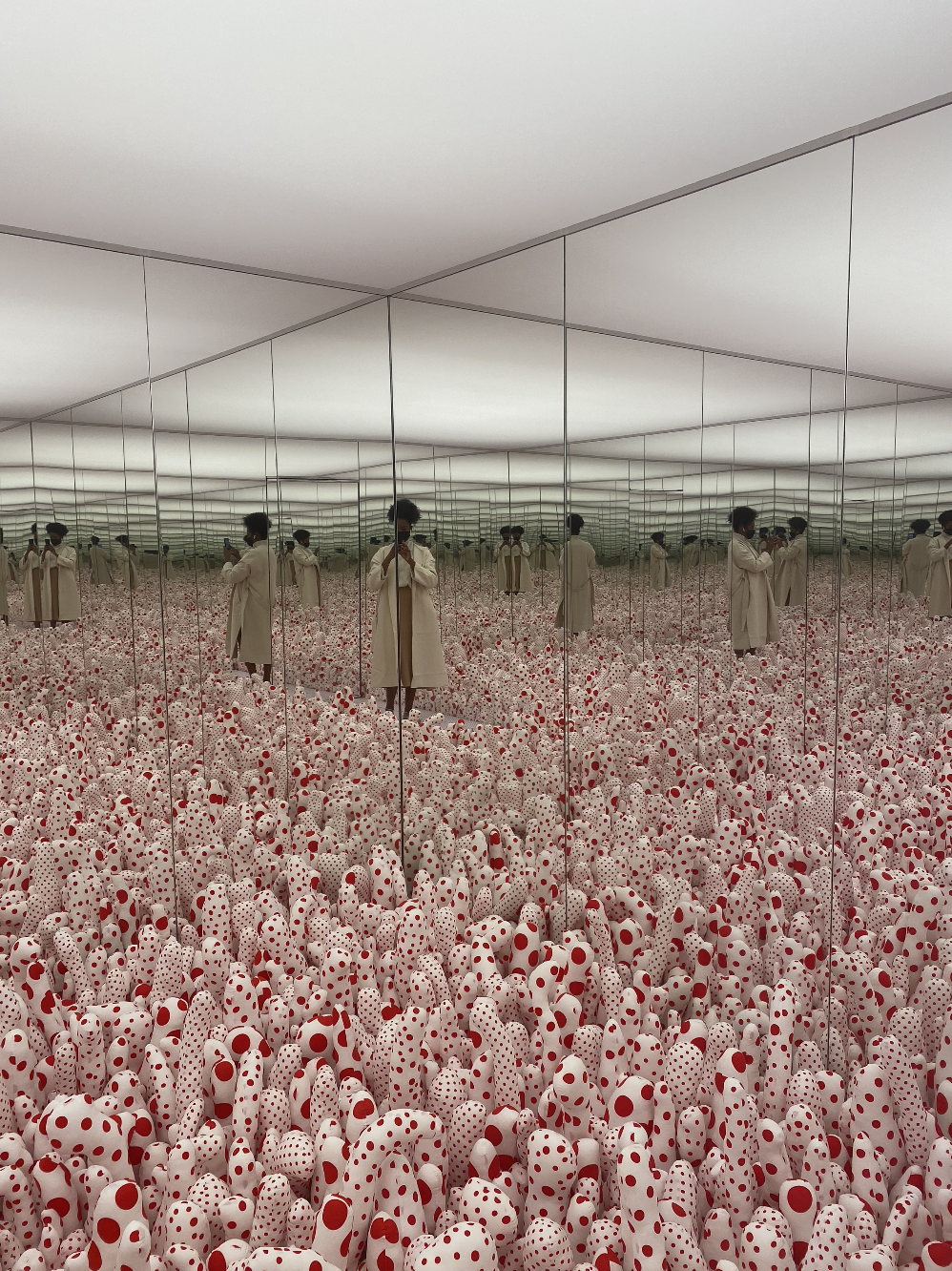 Paige Hopkins takes a picture in Kusama's mirror room, Phalli’s Field.