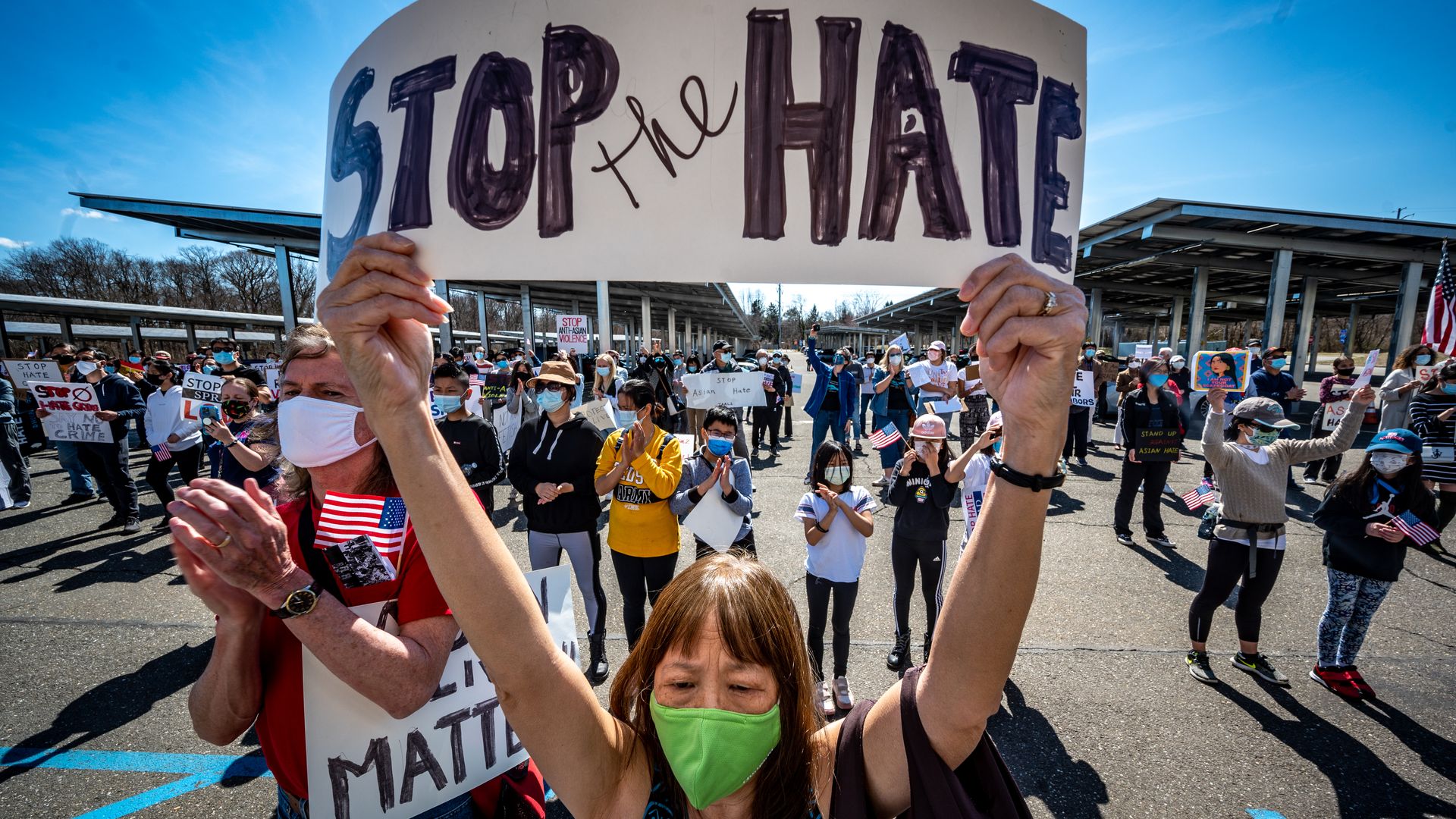 A woman is seen holding a sign during a recent protest against Asian American hate crimes.