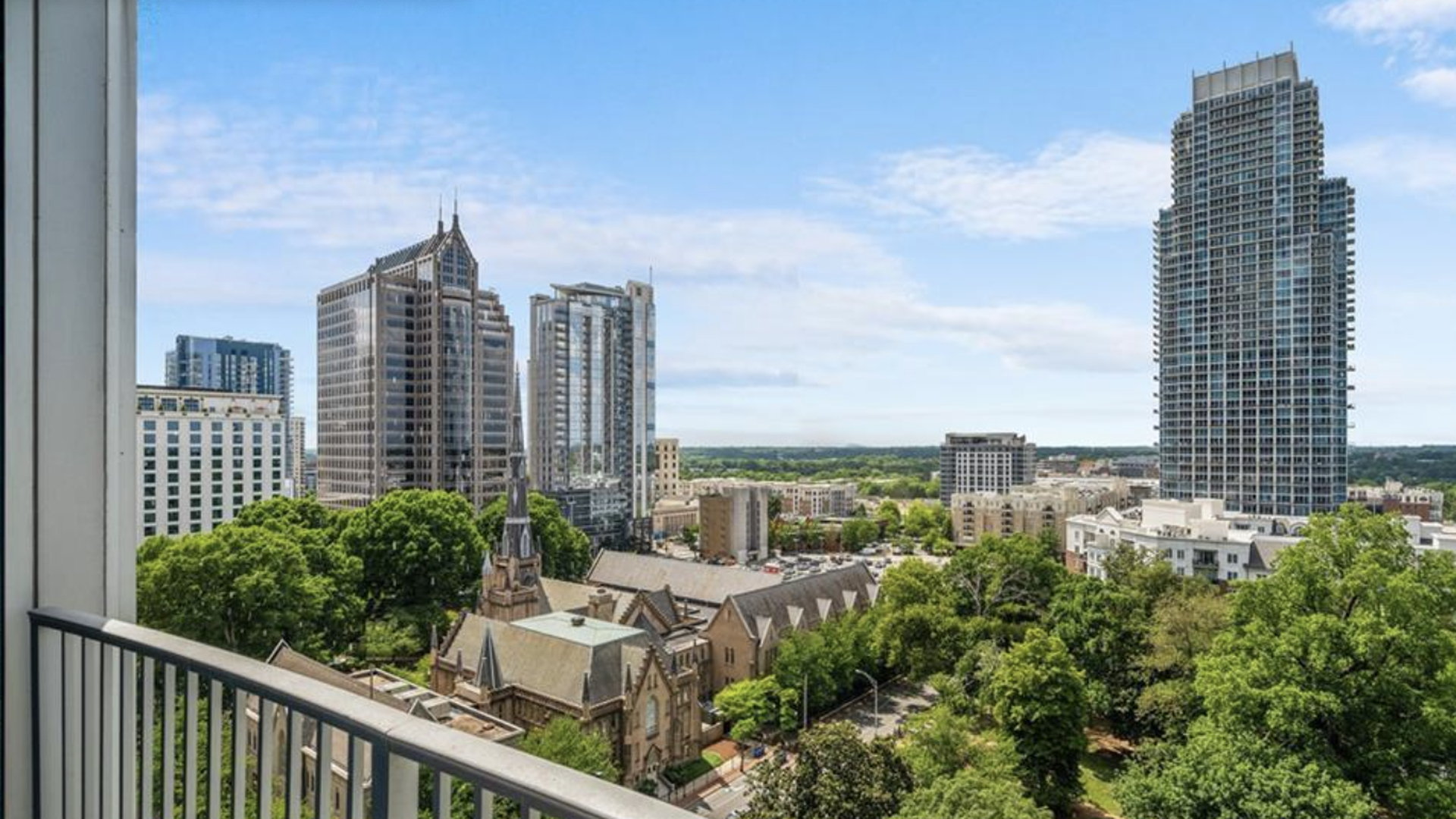 view of skyscrapers off a balcony on a clear day