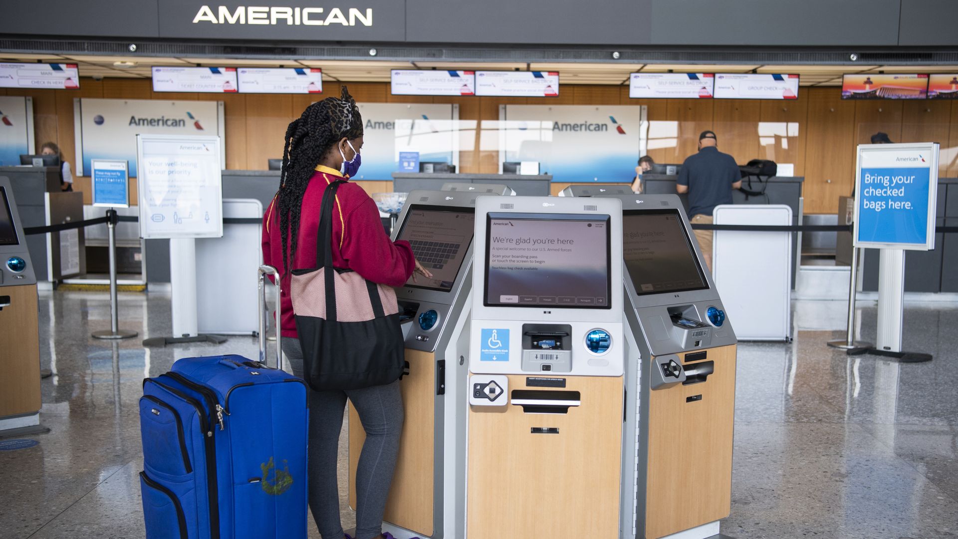 A traveler uses an American Airlines kiosk in Dulles International Airport 