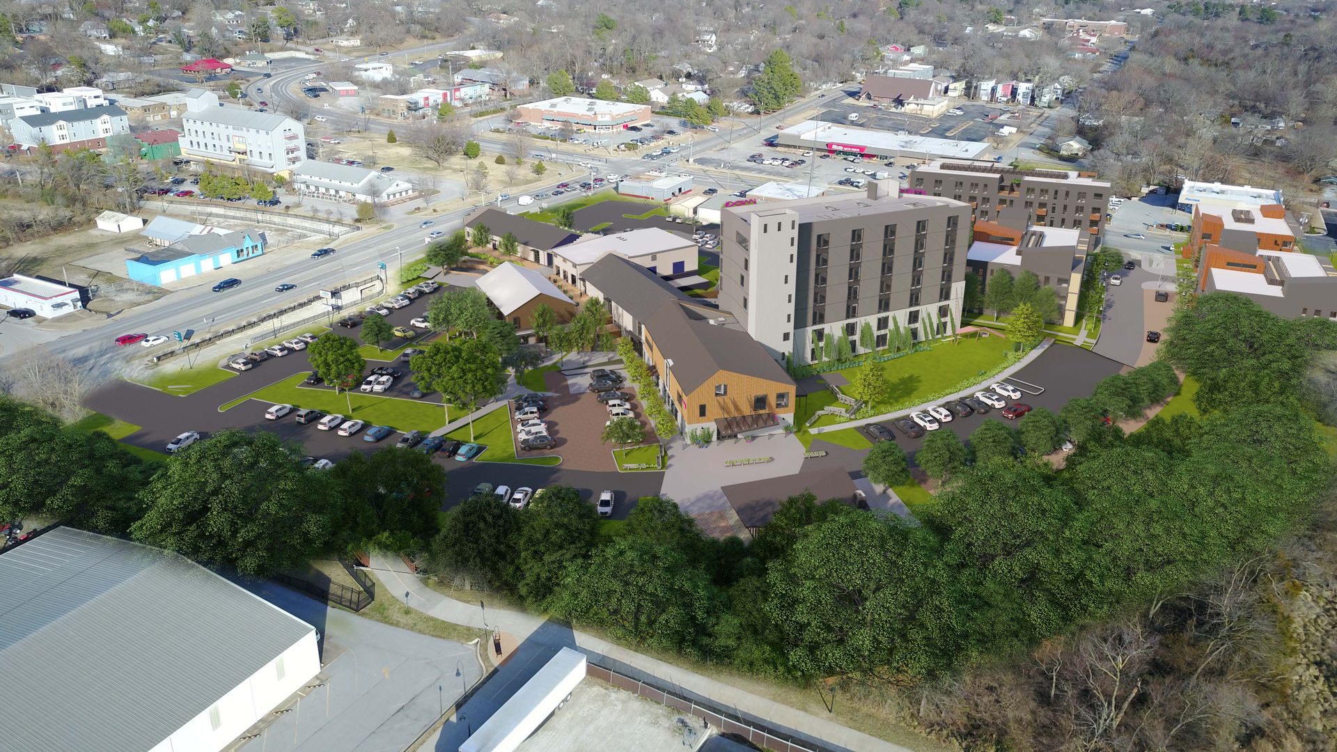 An aerial view rendering of a planned seven-story hotel surrounded by other, smaller buildings and streets.