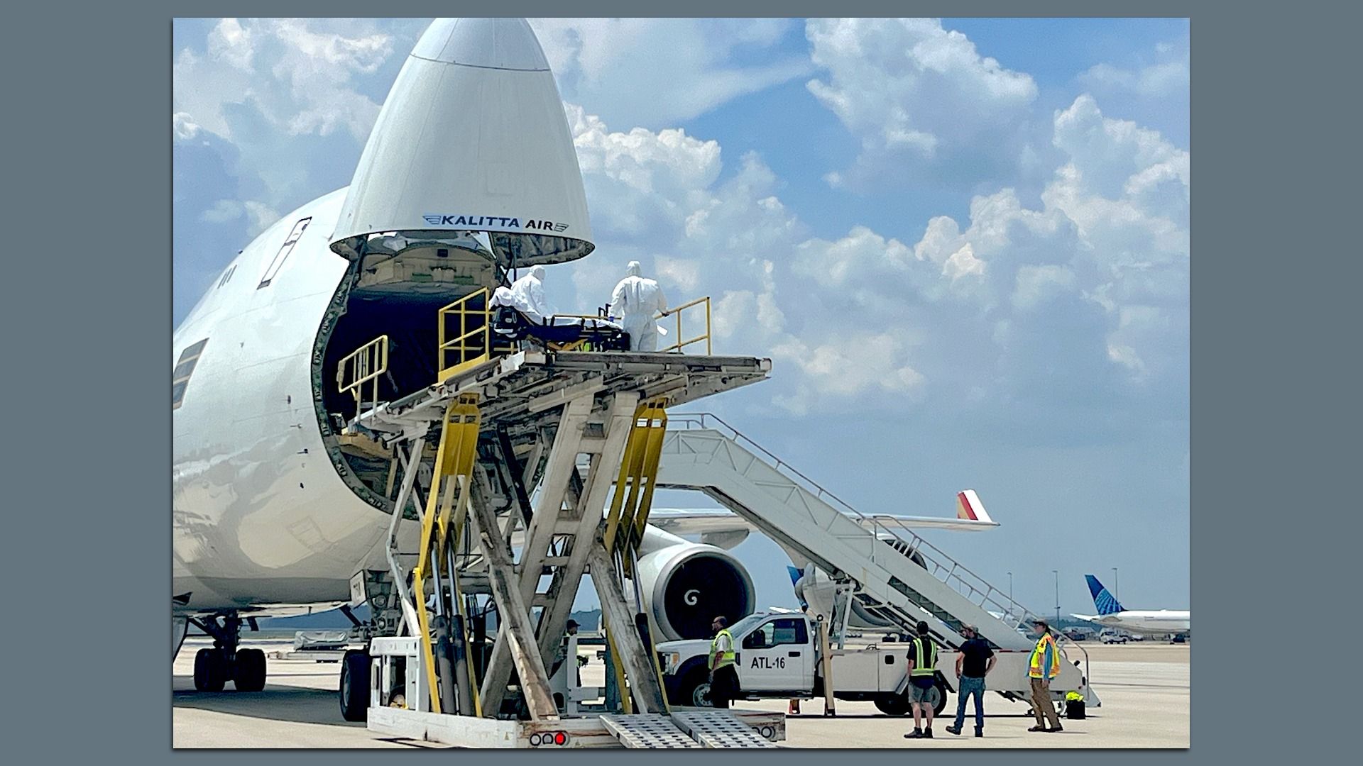 An airplane's nose opens up to allow medical personnel to enter. 