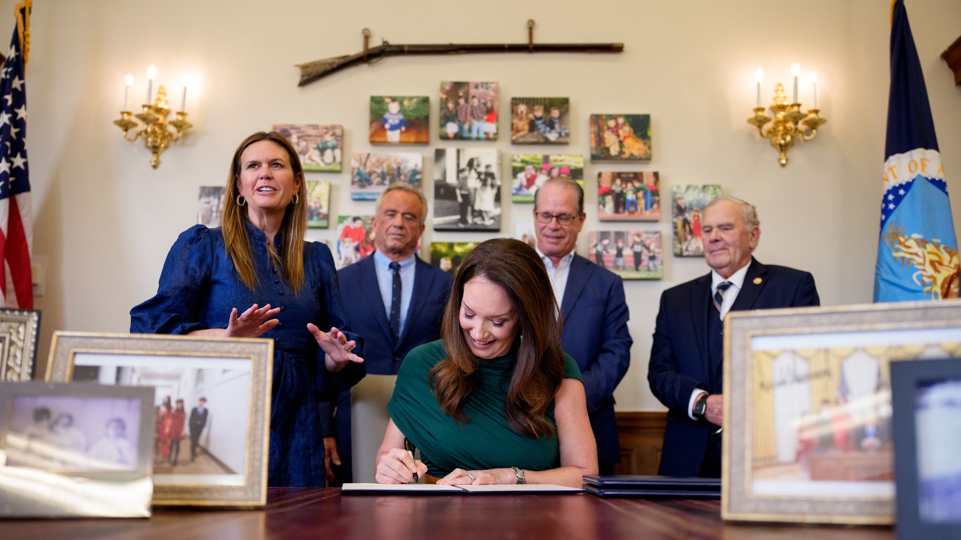 U.S. Agriculture Secretary Brooke Rollins (C), accompanied by (L-R) Arkansas Gov. Sarah Huckabee Sanders, Health and Human Services Secretary Robert F. Kennedy Jr., Indiana Gov. Mike Braun, and Rep. Jim Baird (R-IN), signs one of three new SNAP food choice waivers