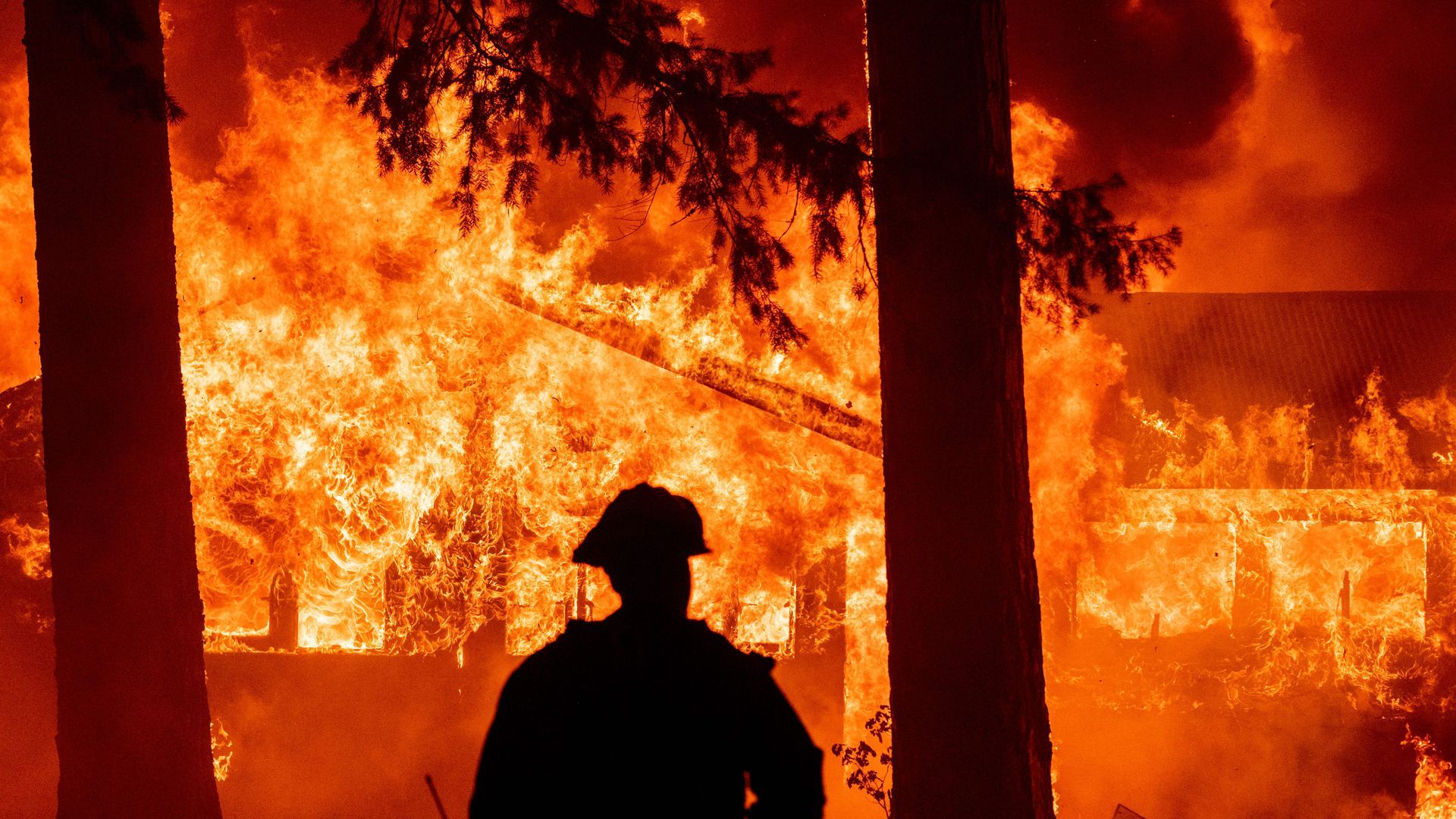 Firefighters on the scene as dozens of homes burn during the Dixie Fire in the Indian Falls neighborhood of unincorporated Plumas County, California, on July 24.