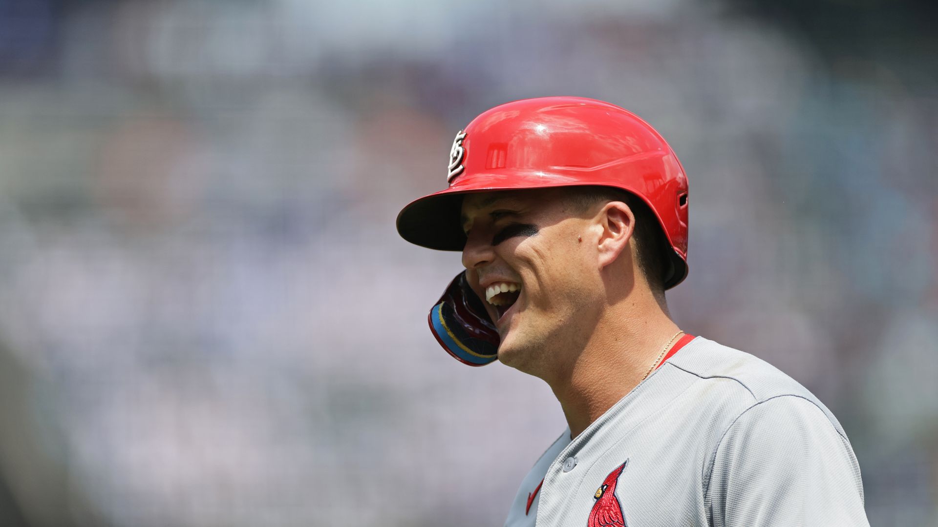 Lars Nootbar smiles in a red helment and St. Louis Cardinals jersey