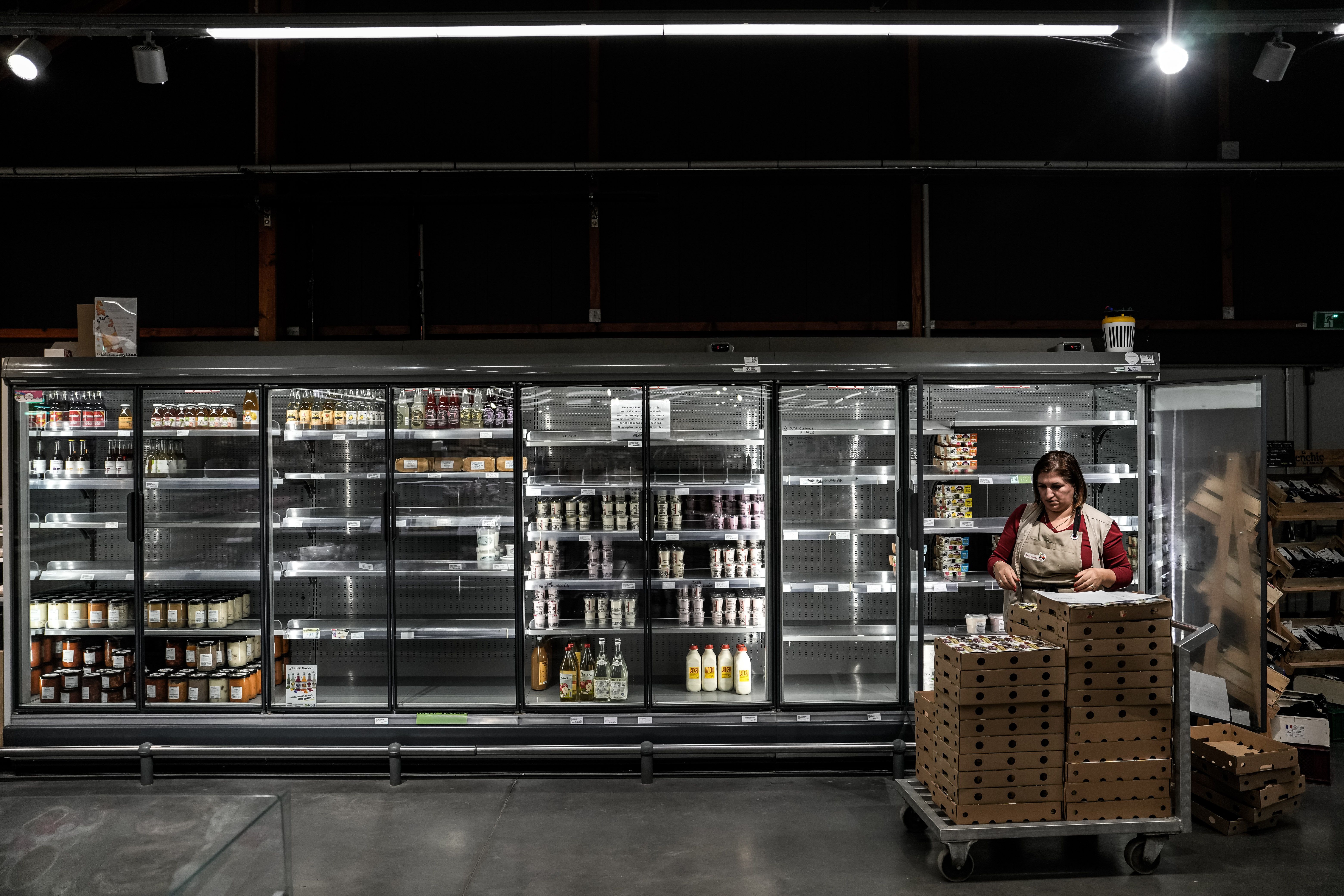 A supermarket employee restocks goods at a store in Nancy, France.