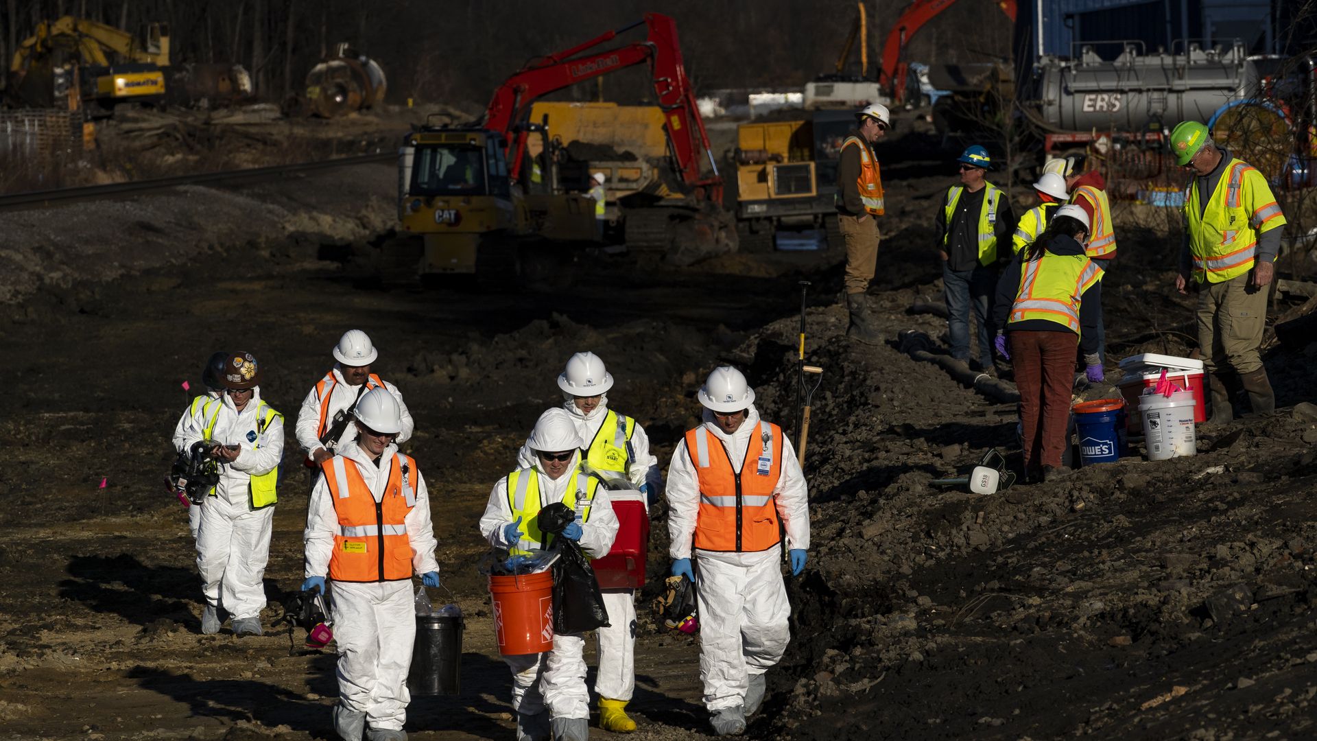 Members of the Ohio EPA and U.S. EPA  collect soil and air samples from the train derailment site in in East Palestine, Ohio, on March 9.