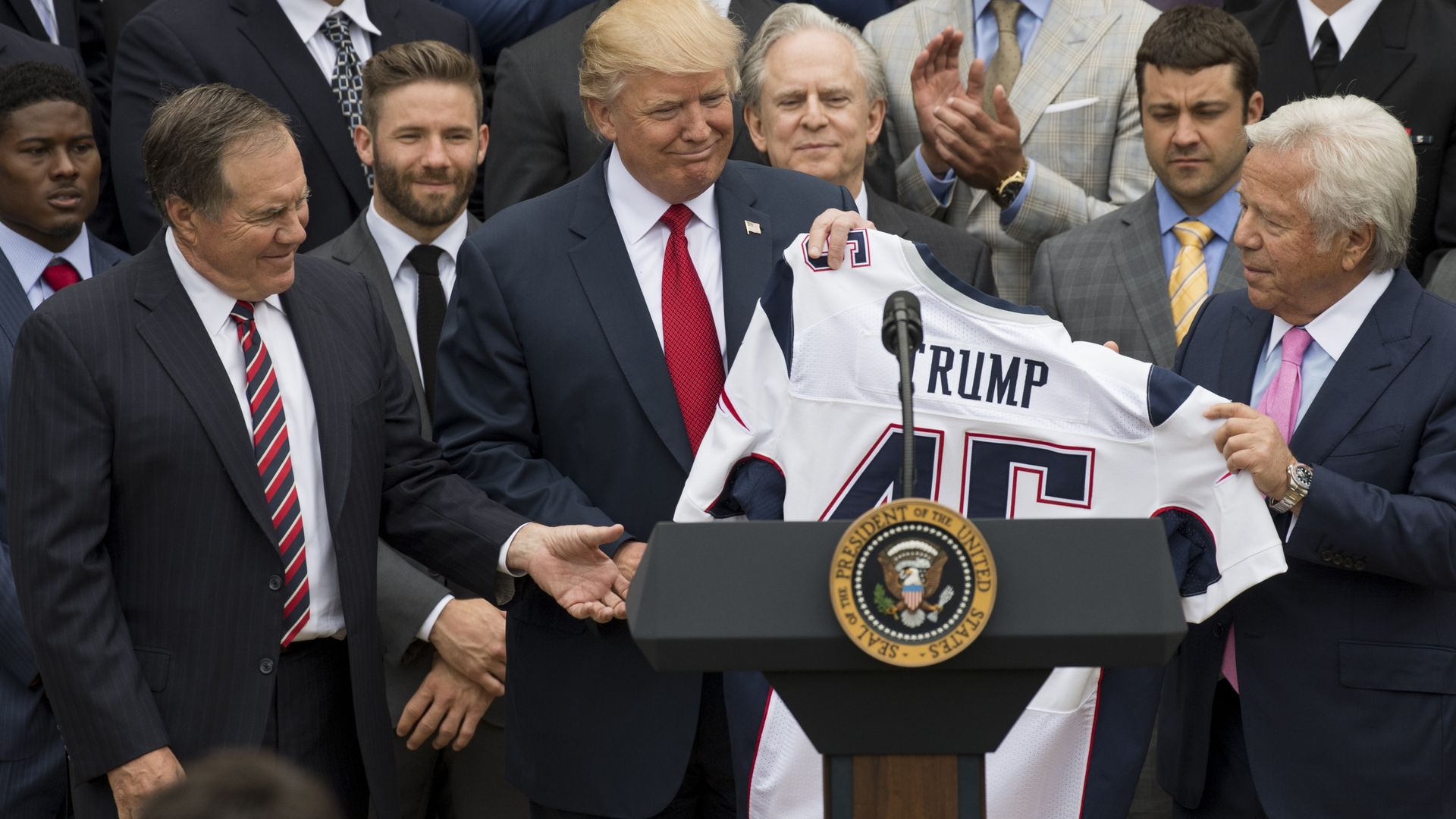 Trump and Kraft and billichek at a podium.