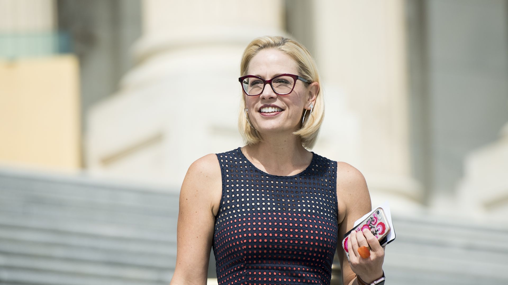 Sen. Kyrsten Sinema is seen on the Capitol steps.
