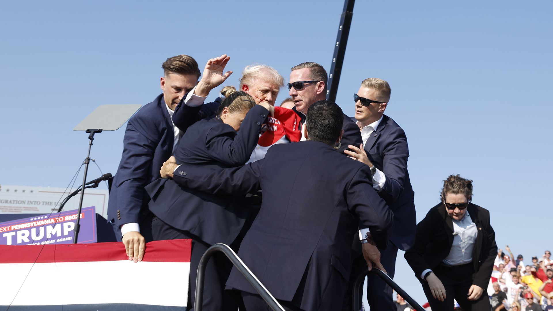 former President Donald Trump is rushed offstage during a rally on July 13, 2024 in Butler, Pennsylvania. Butler County district attorney Richard Goldinger said the shooter is dead after injuring former U.S. President Donald Trump, killing one audience member and injuring another in the shooting. (P