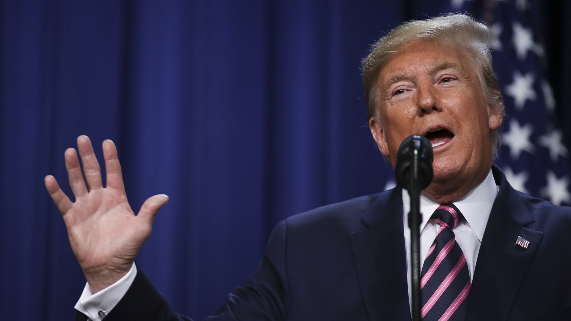 Trump speaks at a podium.