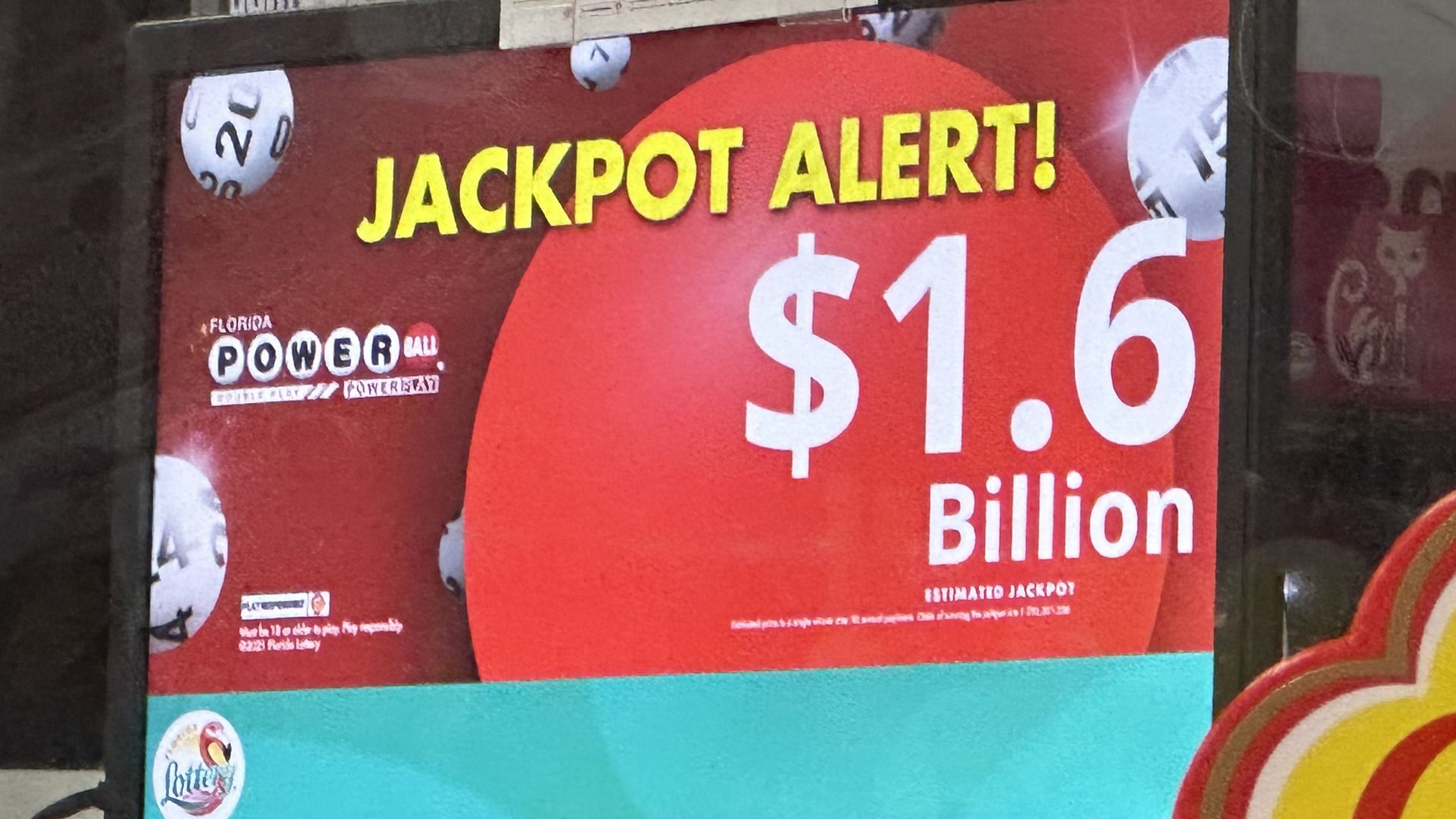 Computer screen with Jackpot Alert! in yellow font, $1.6 billion in white on top of a red ball