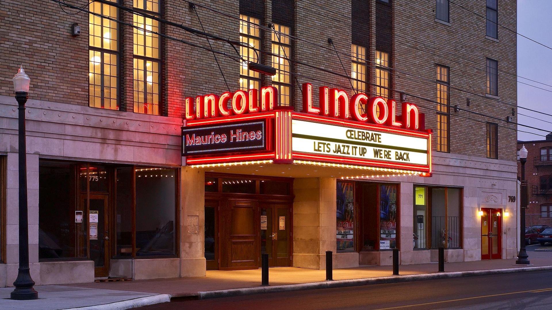 An illuminated Lincoln Theatre marquee at night