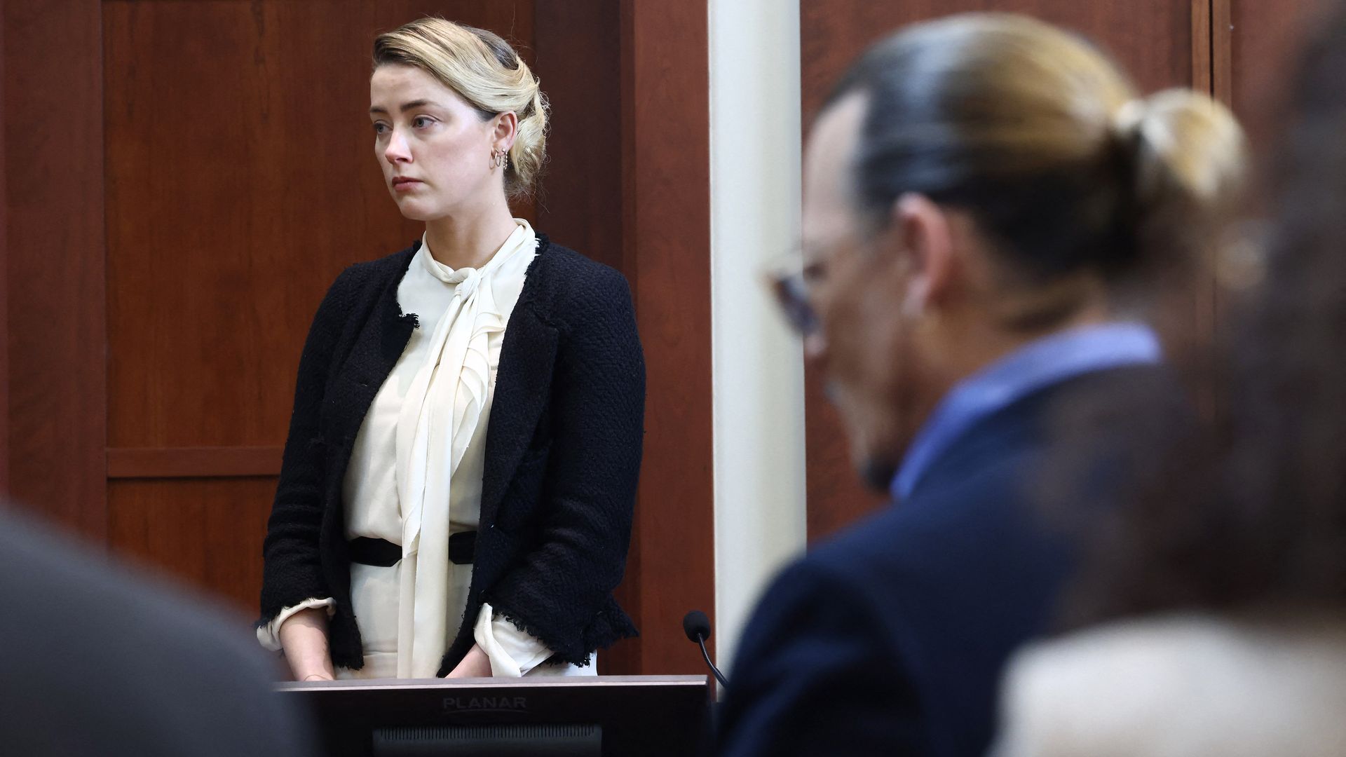 US actress Amber Heard testifies as US actor Johnny Depp looks on.