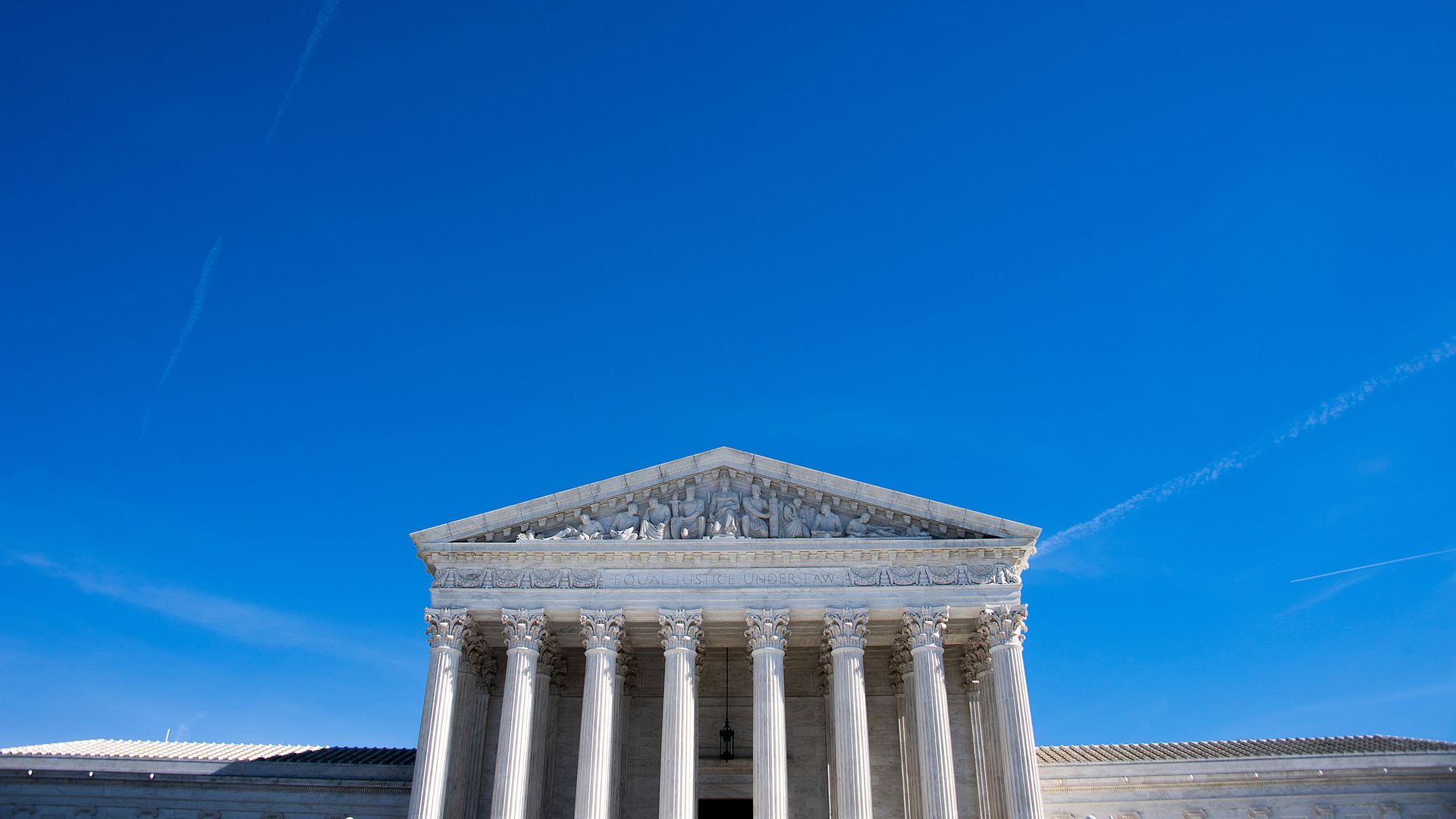 In this image, the Supreme Court is visible against a clear blue sky.