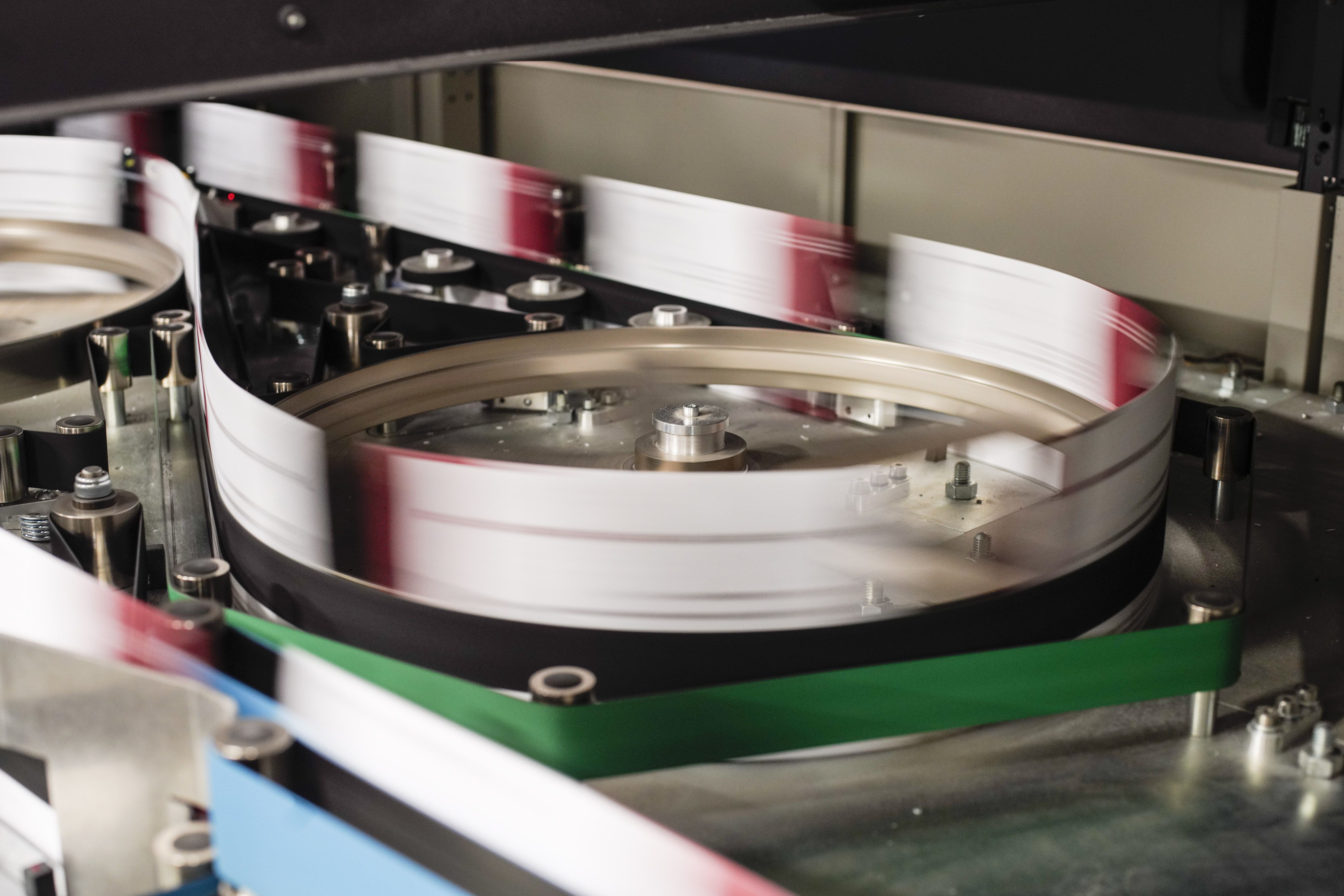 Absentee ballots rapidly spinning through a processing machine. 