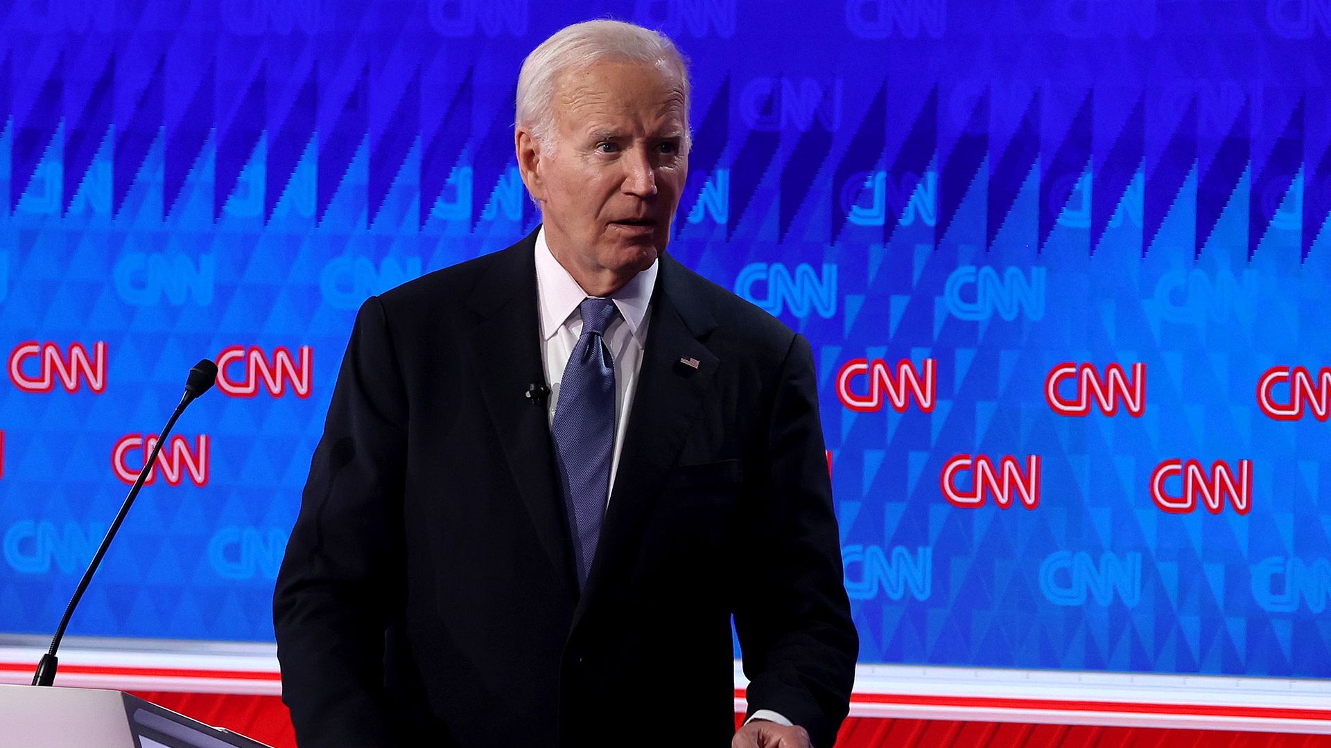 Photo of a man walking away from a podium 