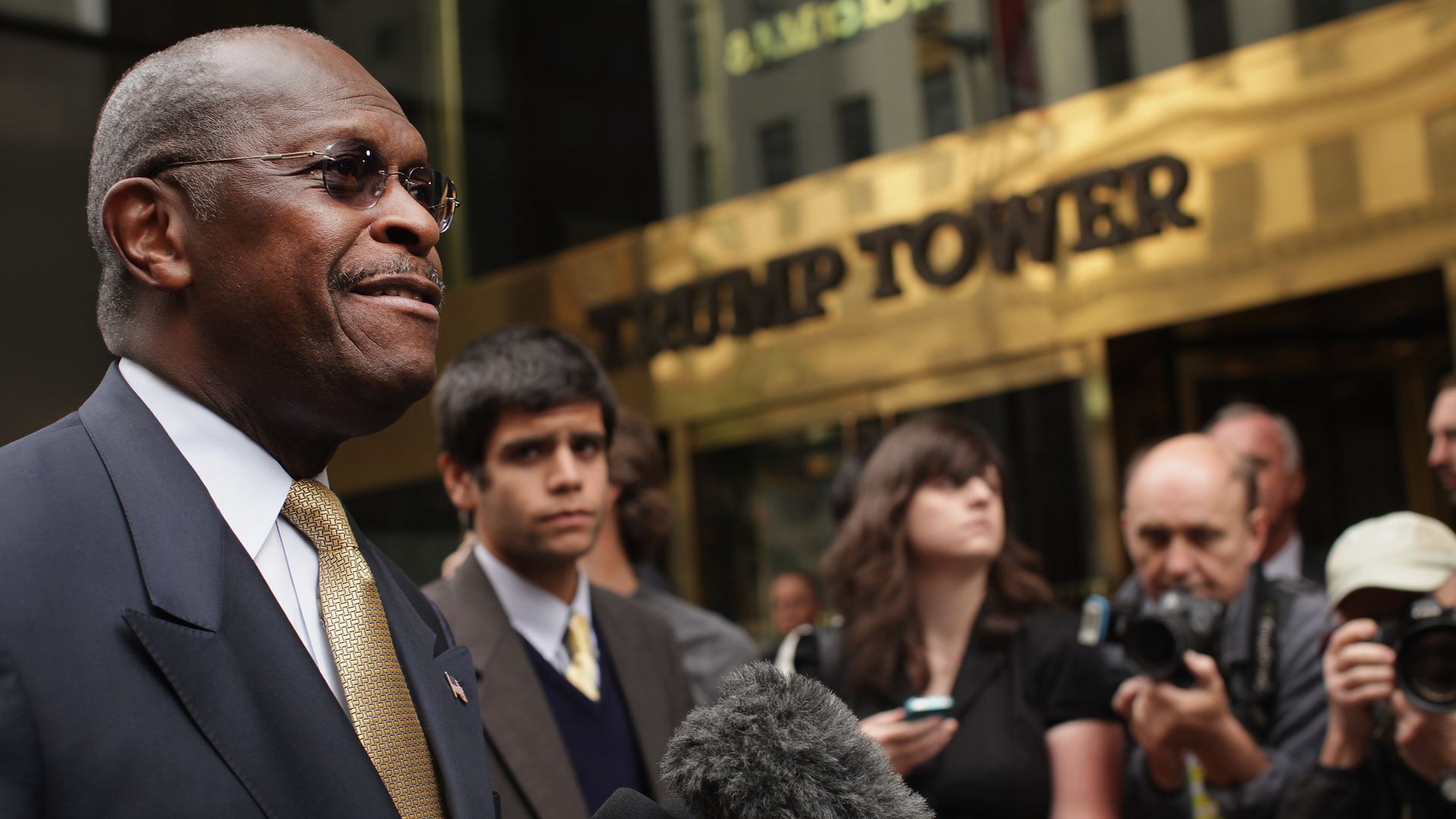 Herman Cain speaks to reporters in front of Trump Tower. 