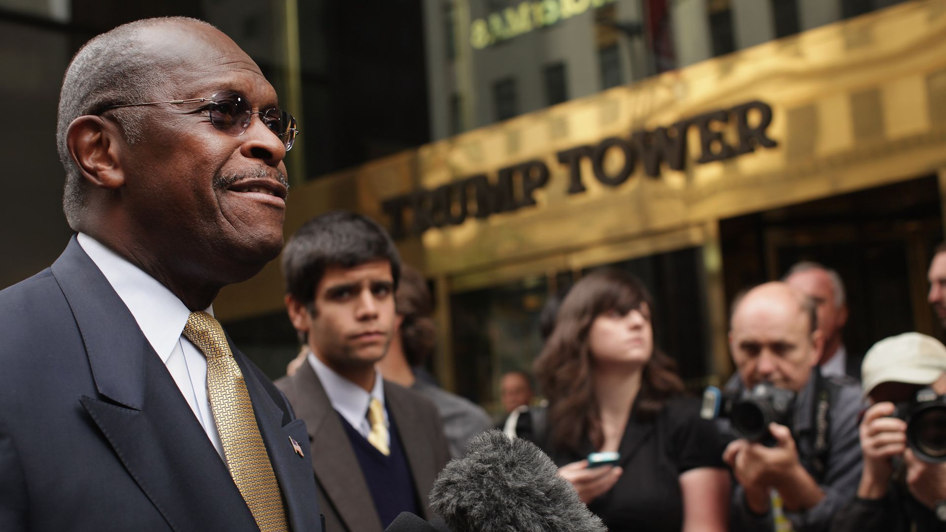 Herman Cain speaks to reporters in front of Trump Tower.