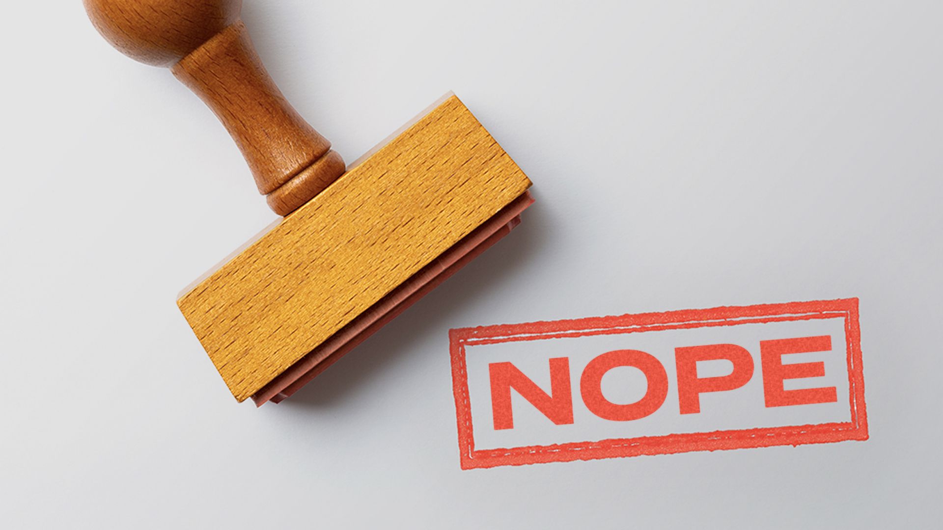 Illustration of a rubber stamp and mark reading "NOPE"