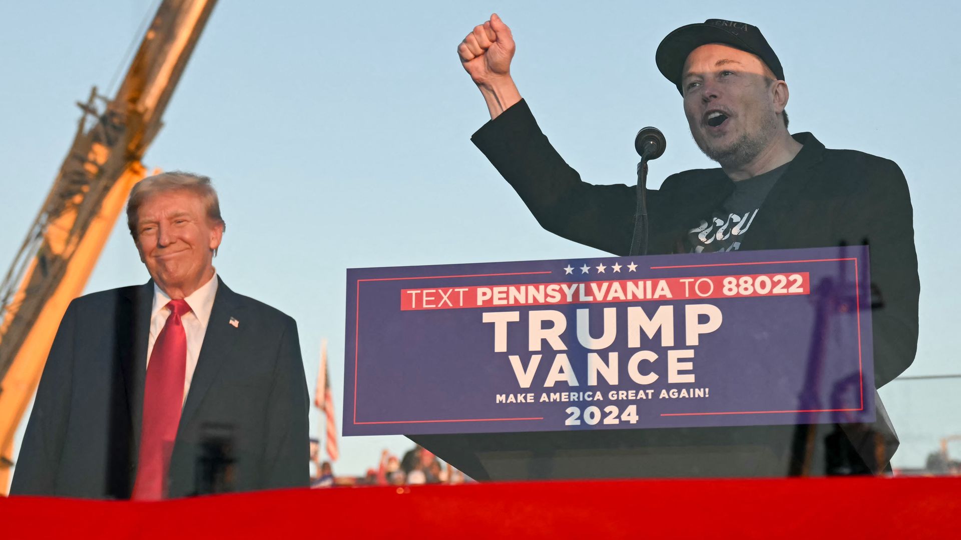 Tesla CEO Elon Musk (R) speaks on stage as he joins former US President and Republican presidential candidate Donald Trump during a campaign rally at site of his first assassination attempt in Butler, Pennsylvania on October 5, 2024.