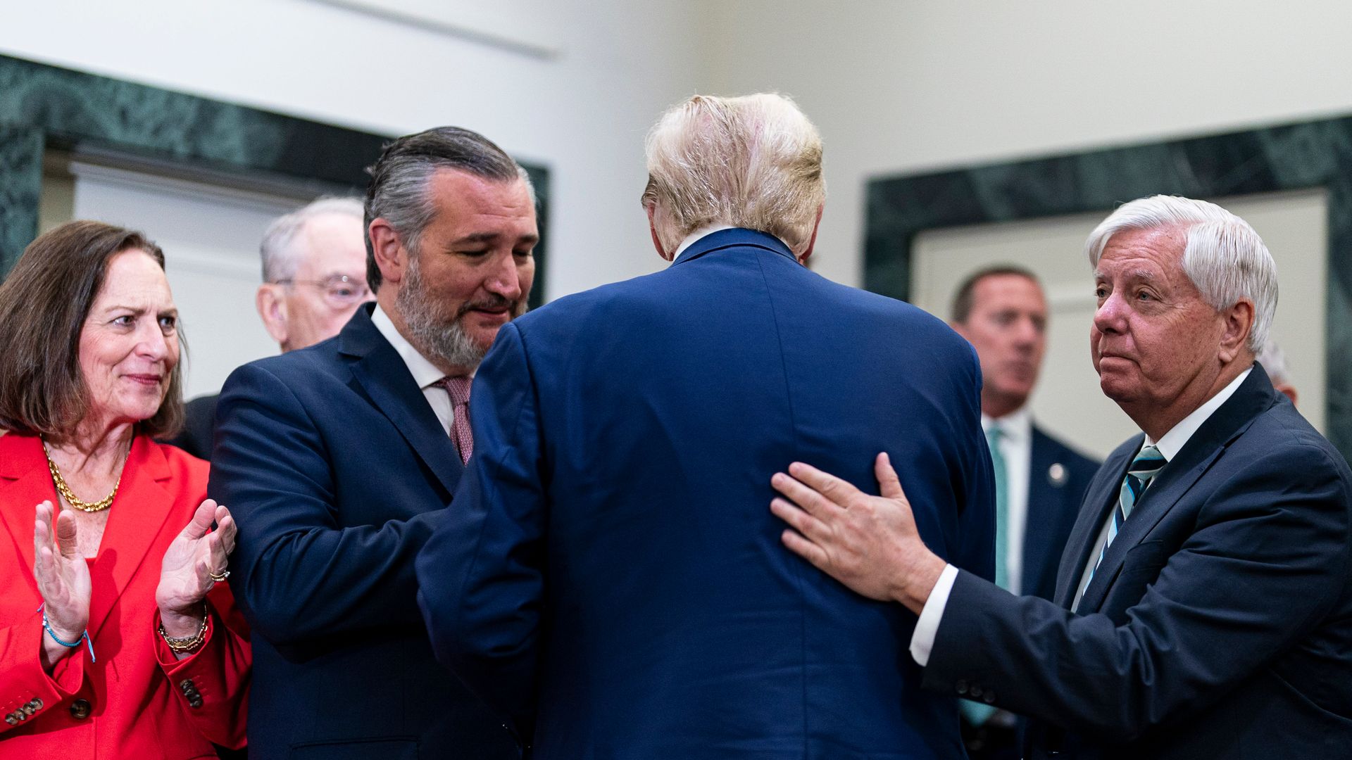A photo of Sen. Ted Cruz greeting former President Trump