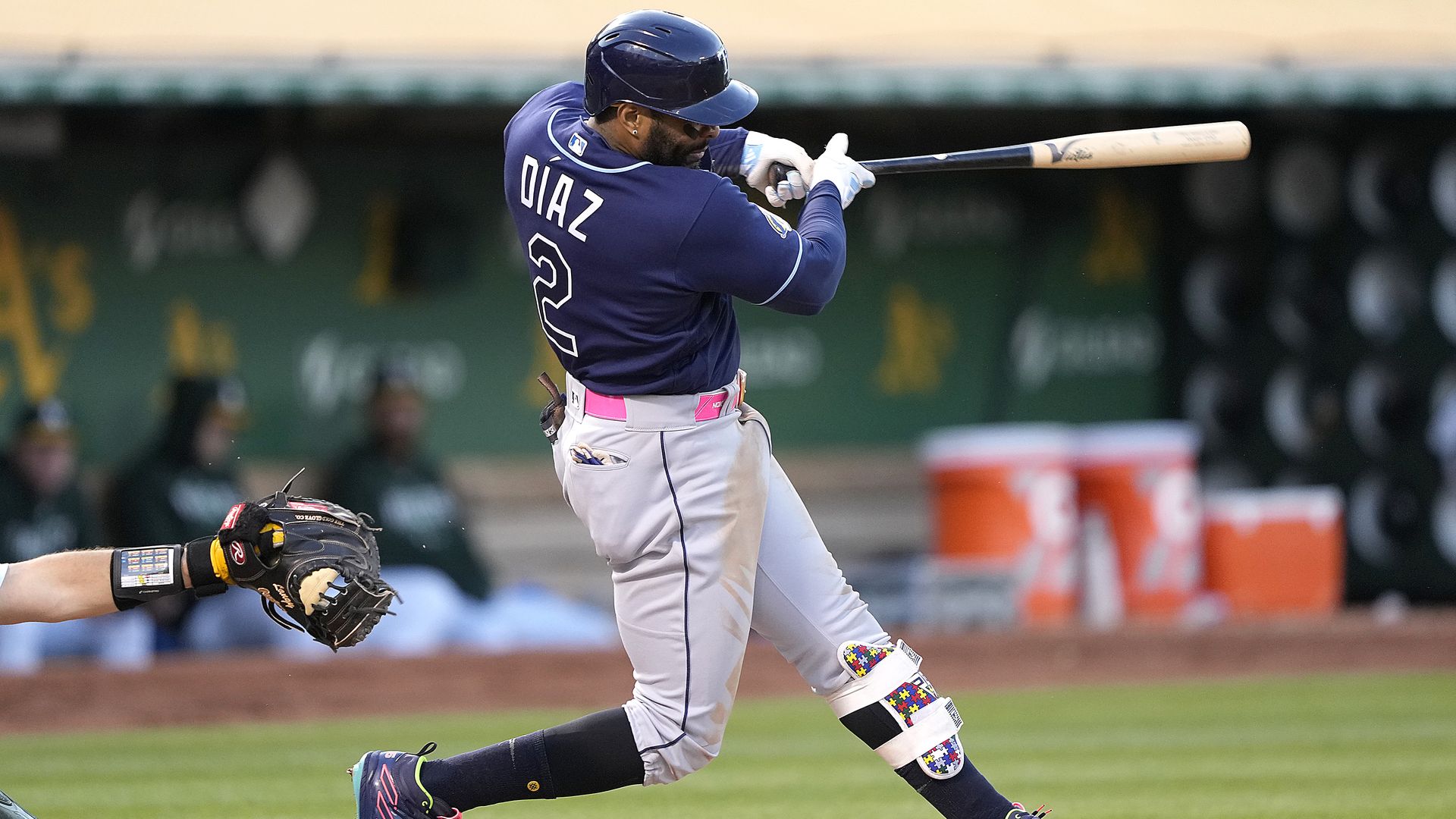 Tampa Bay Rays first baseman Yandy Díaz swinging his bat, wearing a navy jersey.