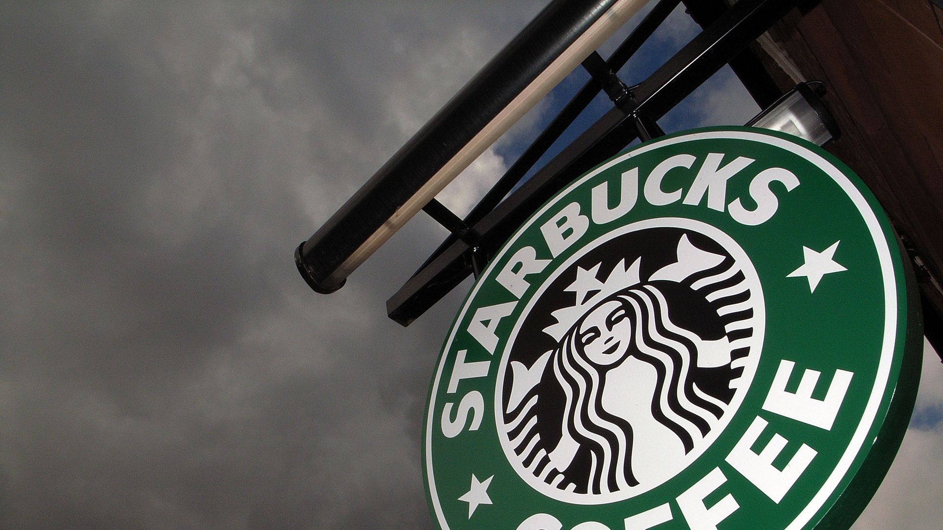 The Starbucks logo hangs outside one of the company's cafes in Northwich, England. 