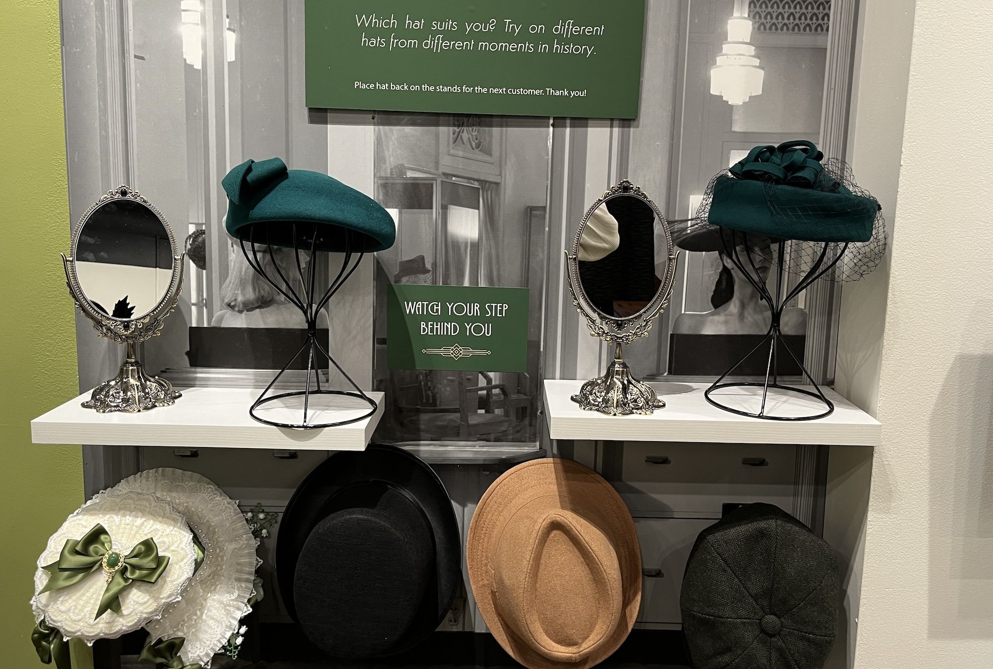 Mirrors and hats on stands on shelves.