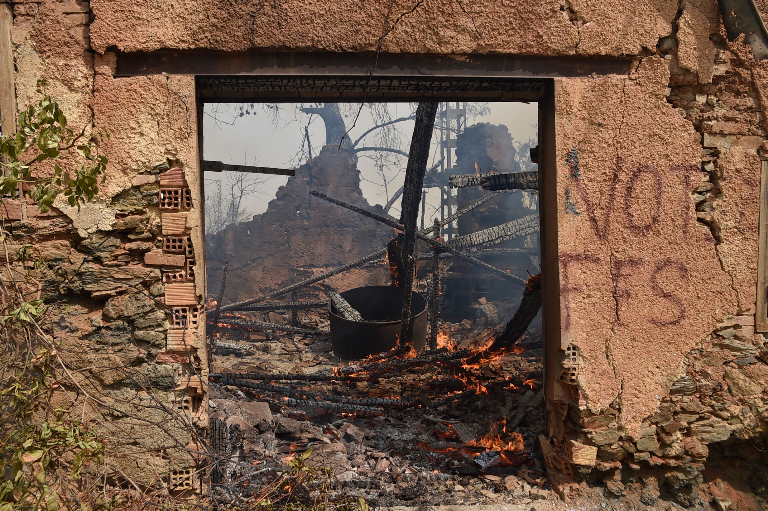 A house burns during a wildfire 