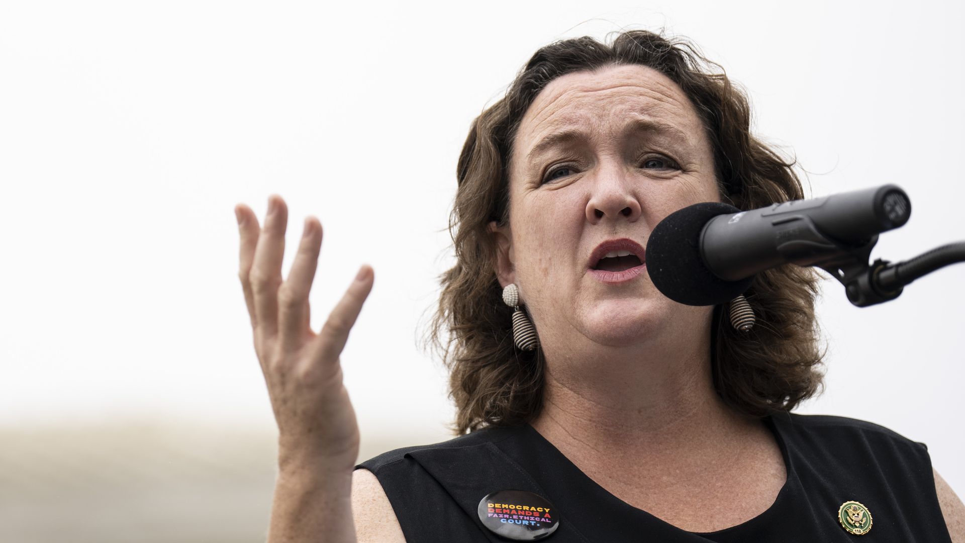 Rep. Katie Porter (D-CA) speaks during a small rally in front of the U.S. Supreme Court calling for ethics reform