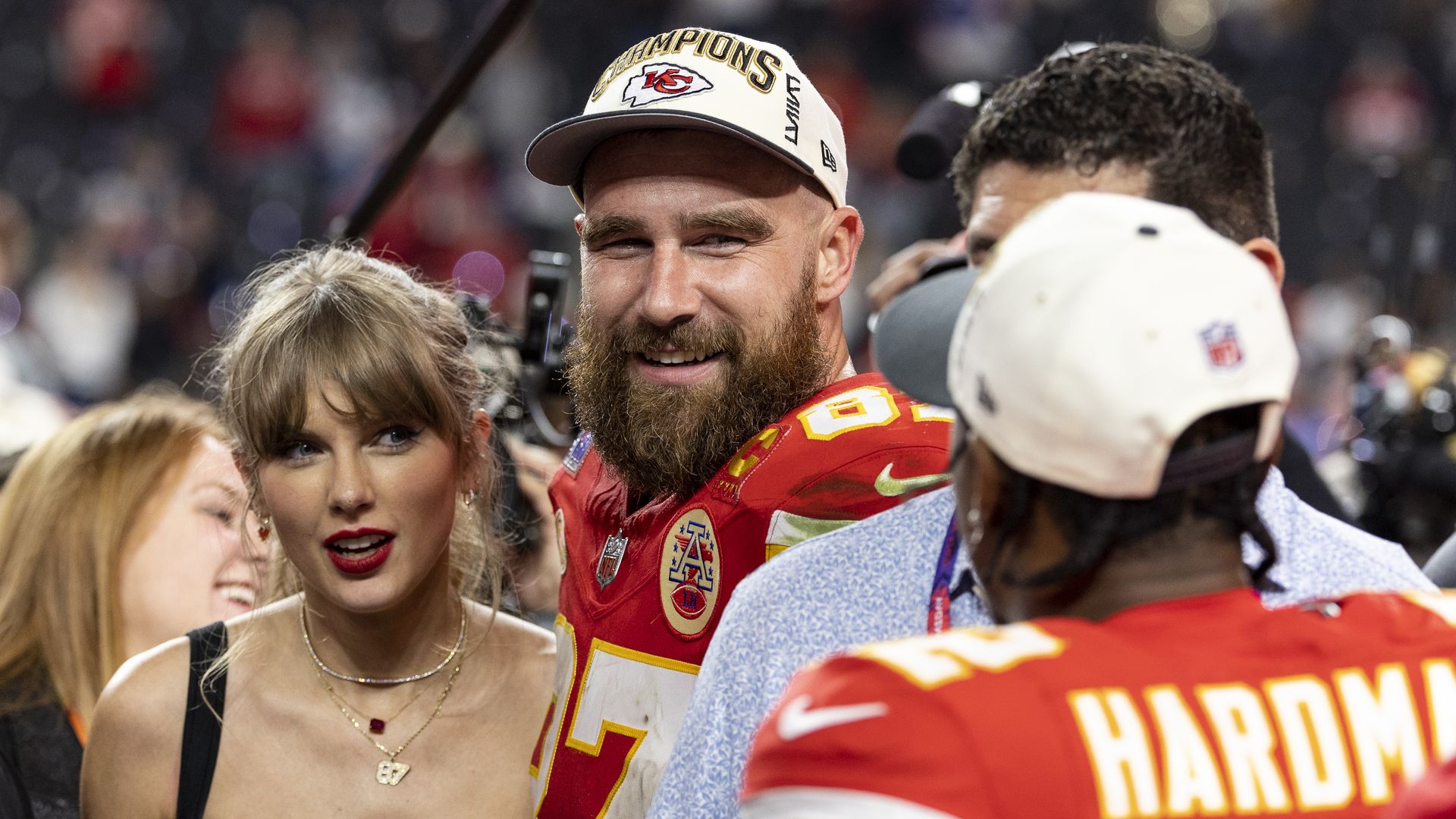 Taylor Swift and Travis Kelce standing next to each other 